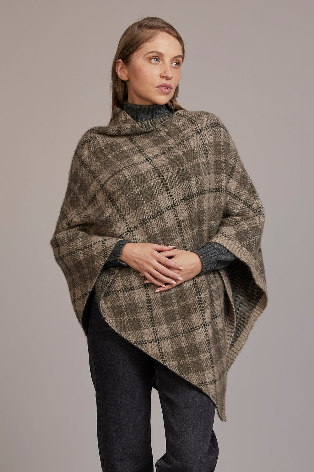 Beige argyle wool poncho with charcoal trim worn by model against neutral background. - Yellow Earth Australia