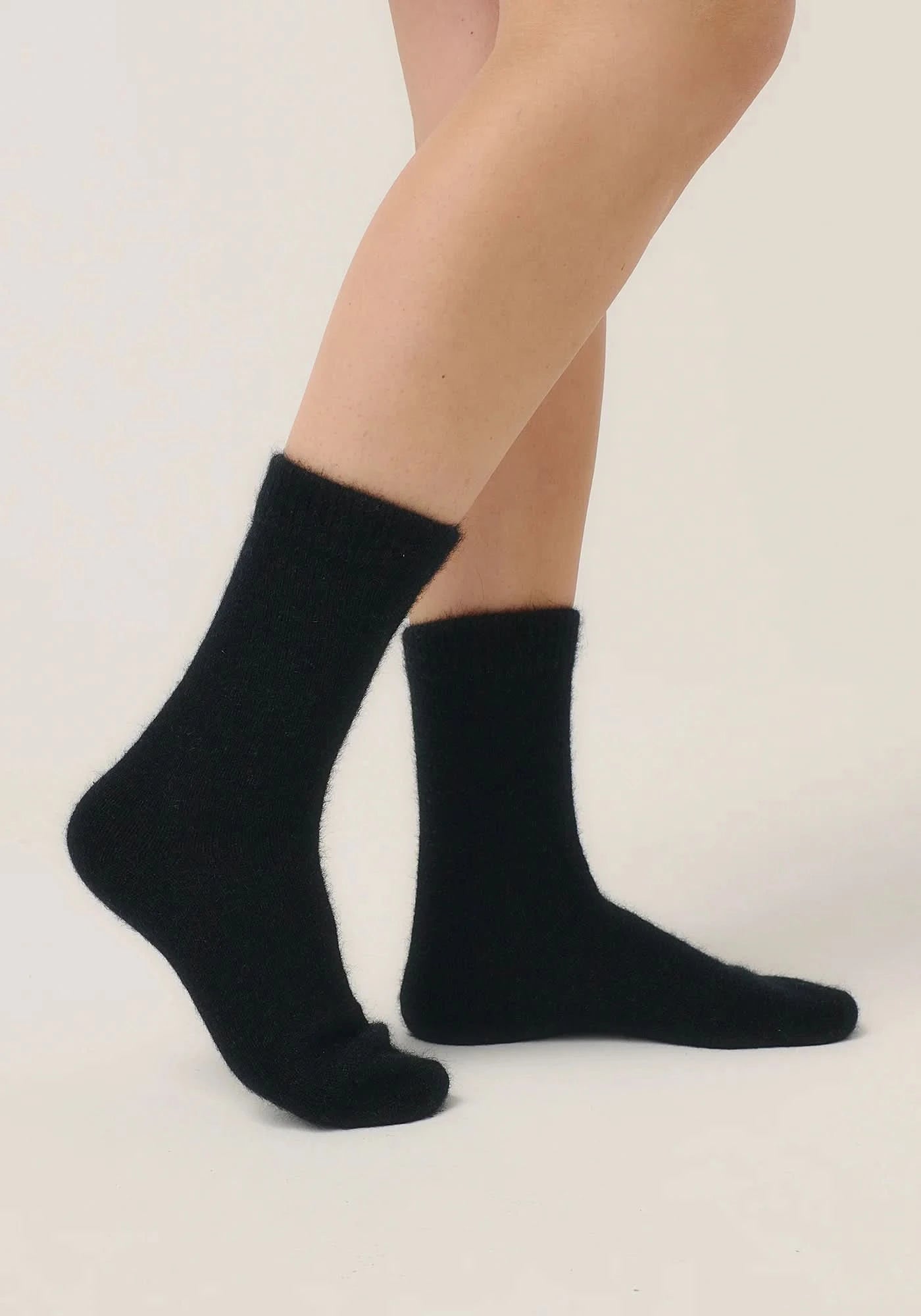 Black wool crew socks displayed on feet against neutral background. - Yellow Earth Australia