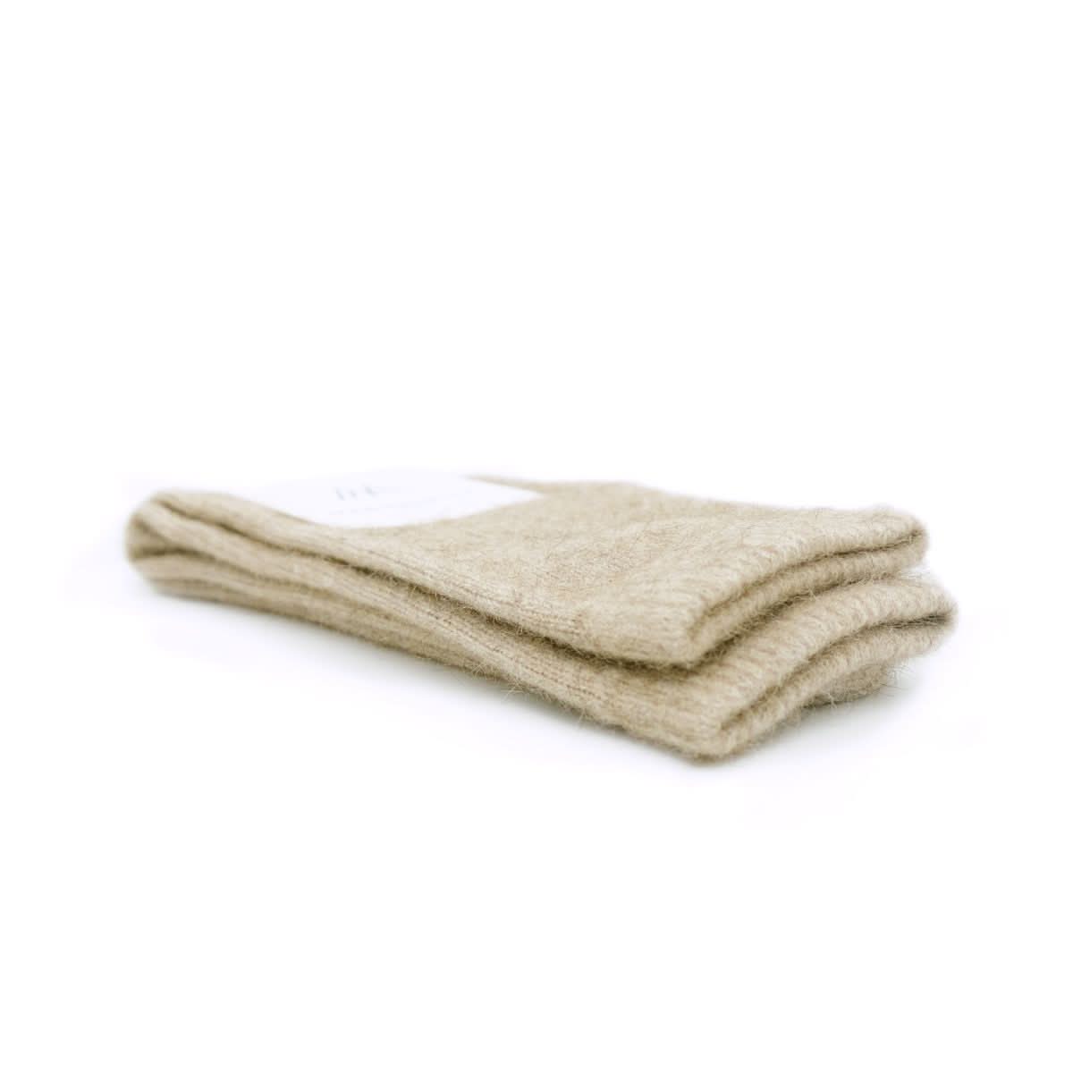 Pair of cream wool socks displayed stacked against white background, showing soft knit texture. - Yellow Earth Australia