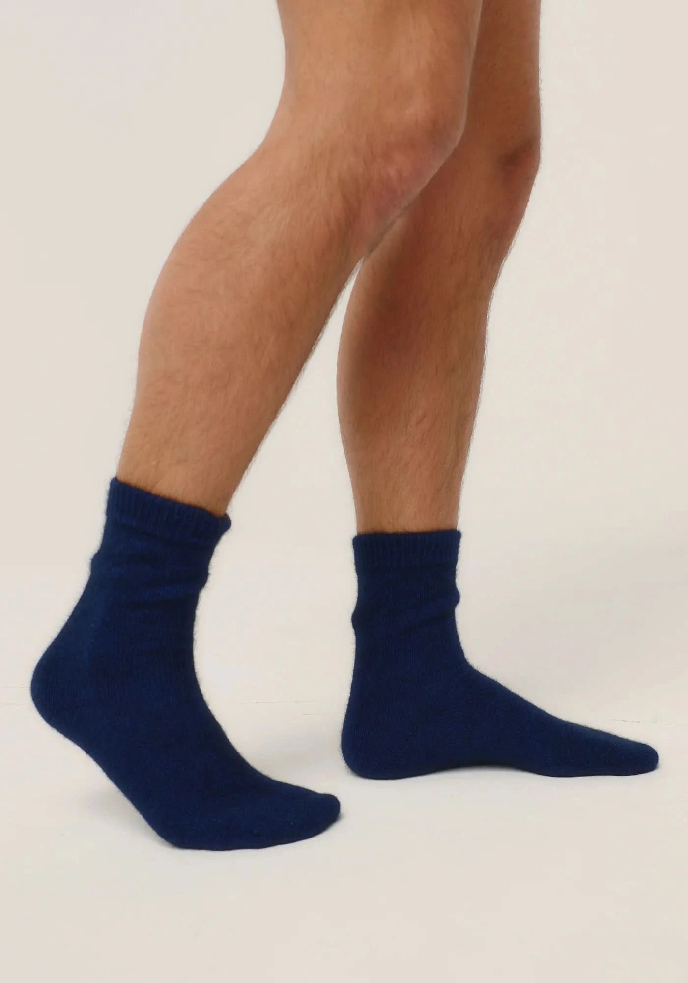 Navy blue wool ankle socks displayed on male legs from side view. - Yellow Earth Australia