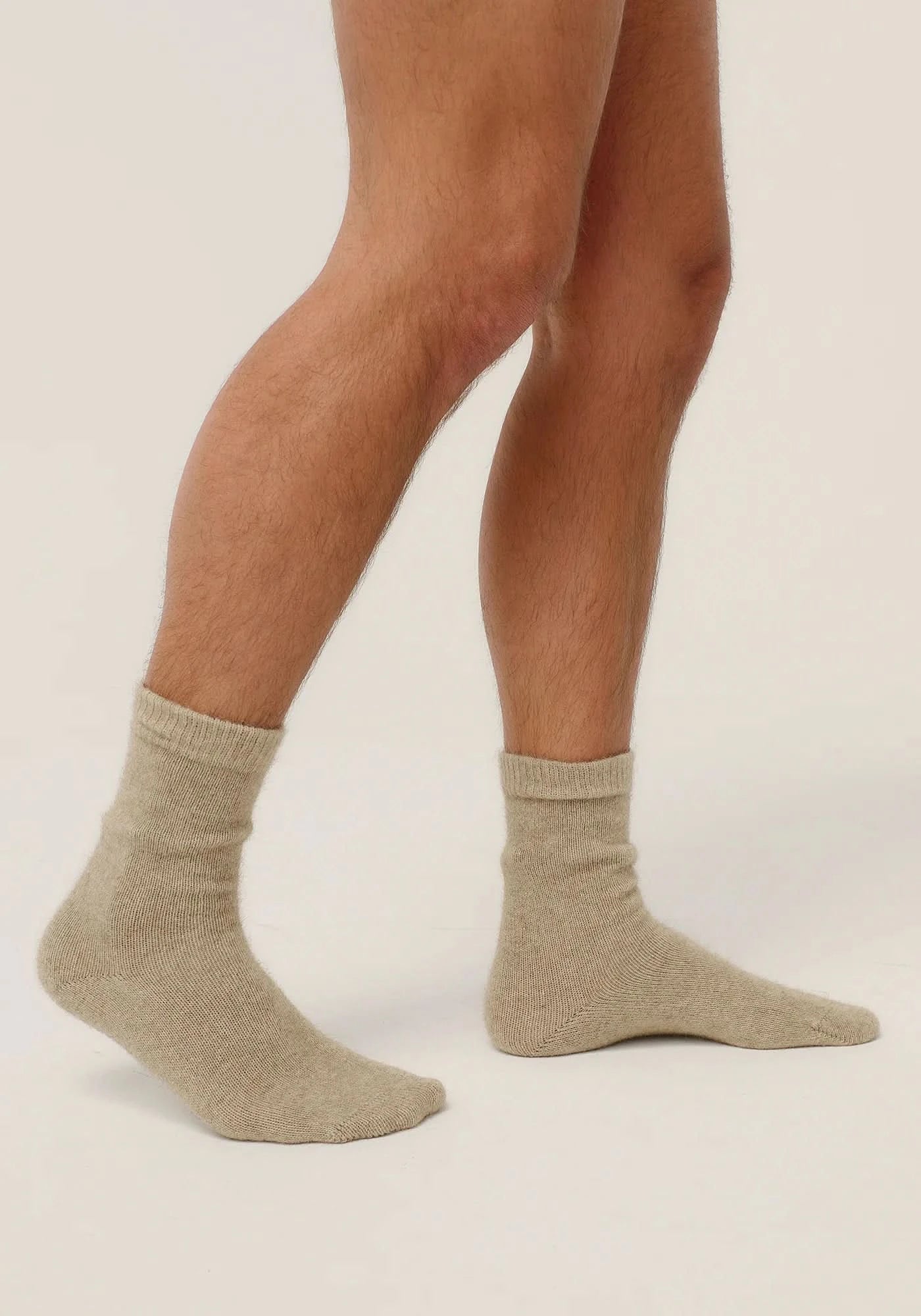 Beige wool crew socks on male legs, side view showing texture and fit. - Yellow Earth Australia