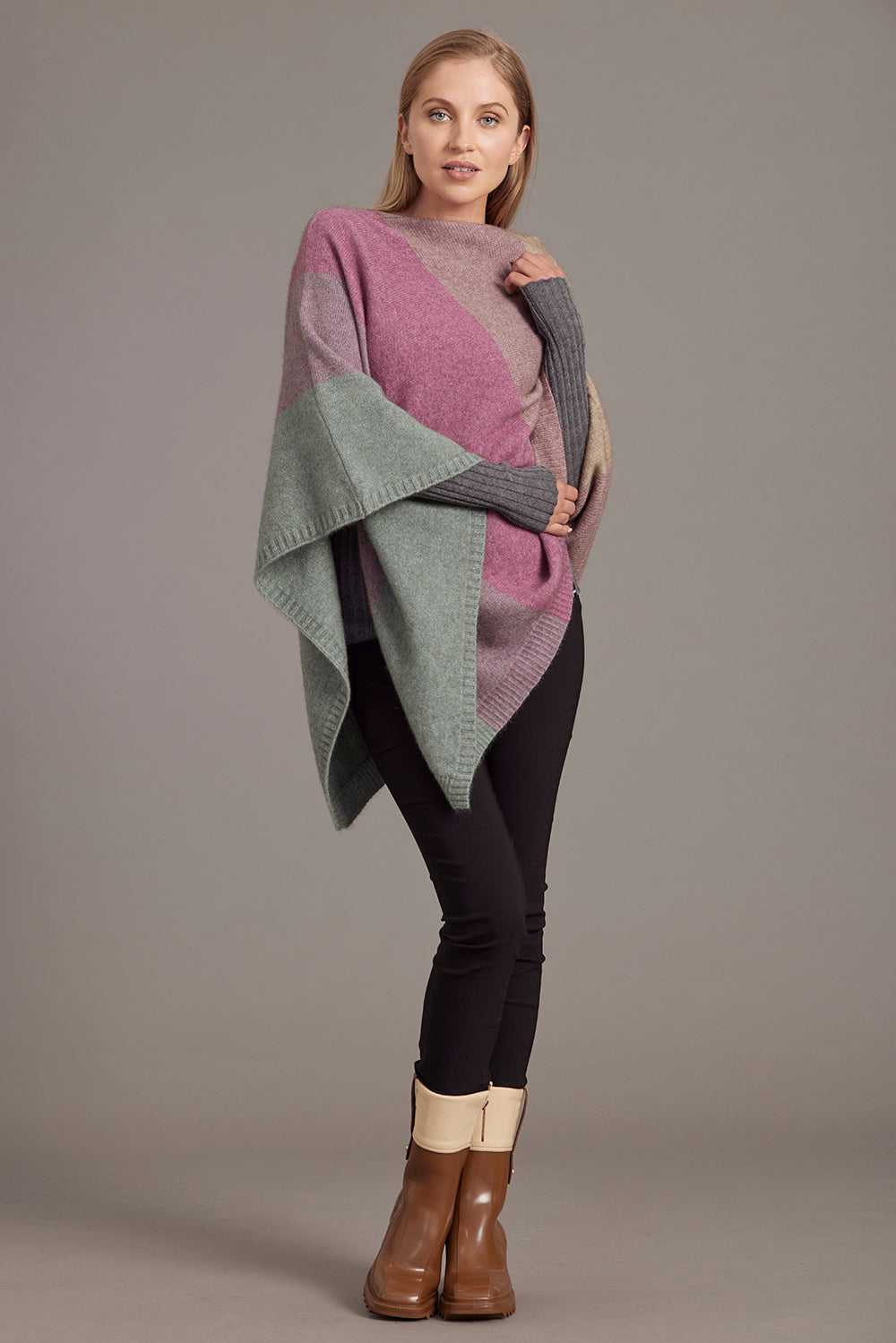 Colorblock wool wrap in pink, grey and beige draped over shoulder, paired with black leggings. - Yellow Earth Australia