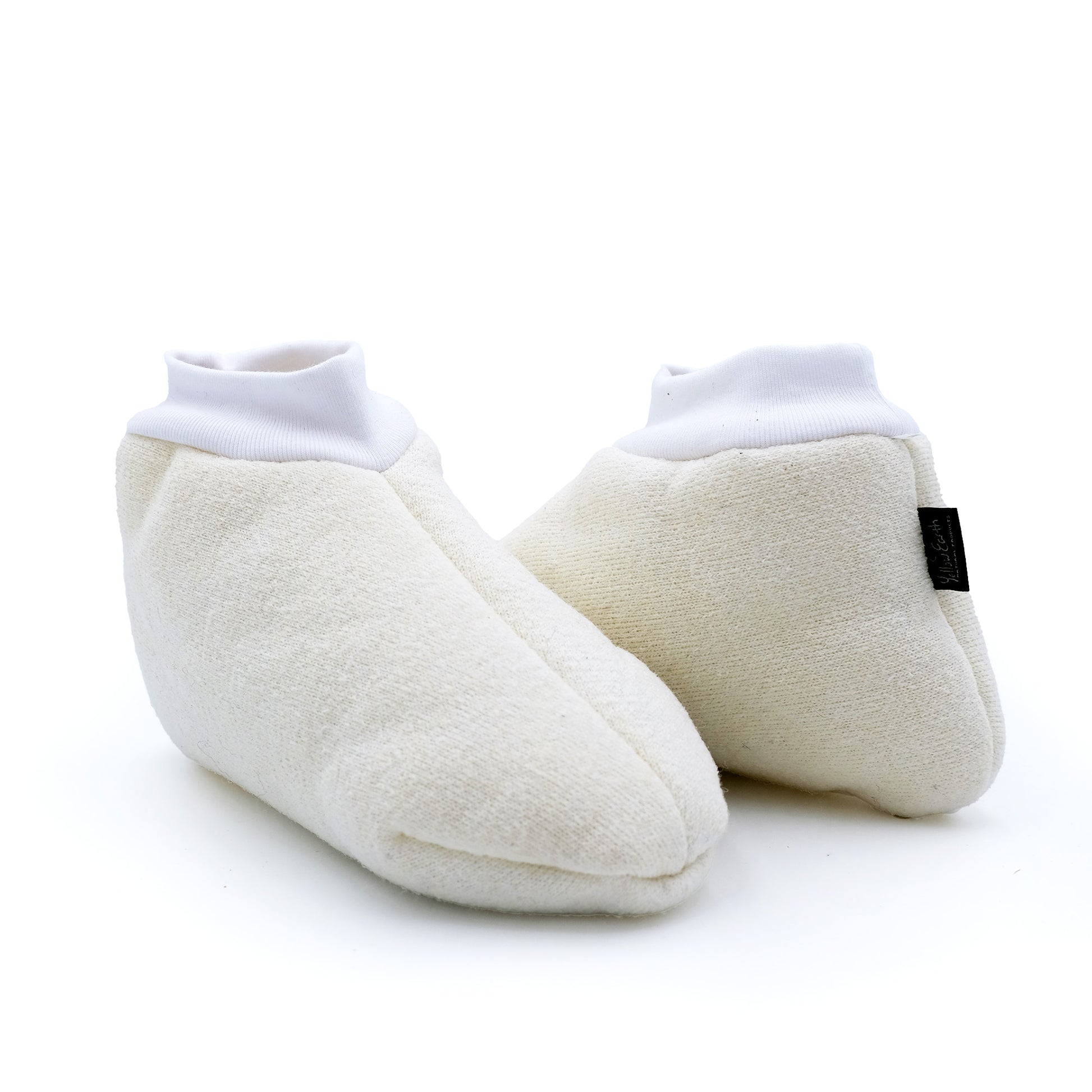 Pair of cream wool baby booties with white cuffed ankles, displayed from the side view. - Yellow Earth Australia