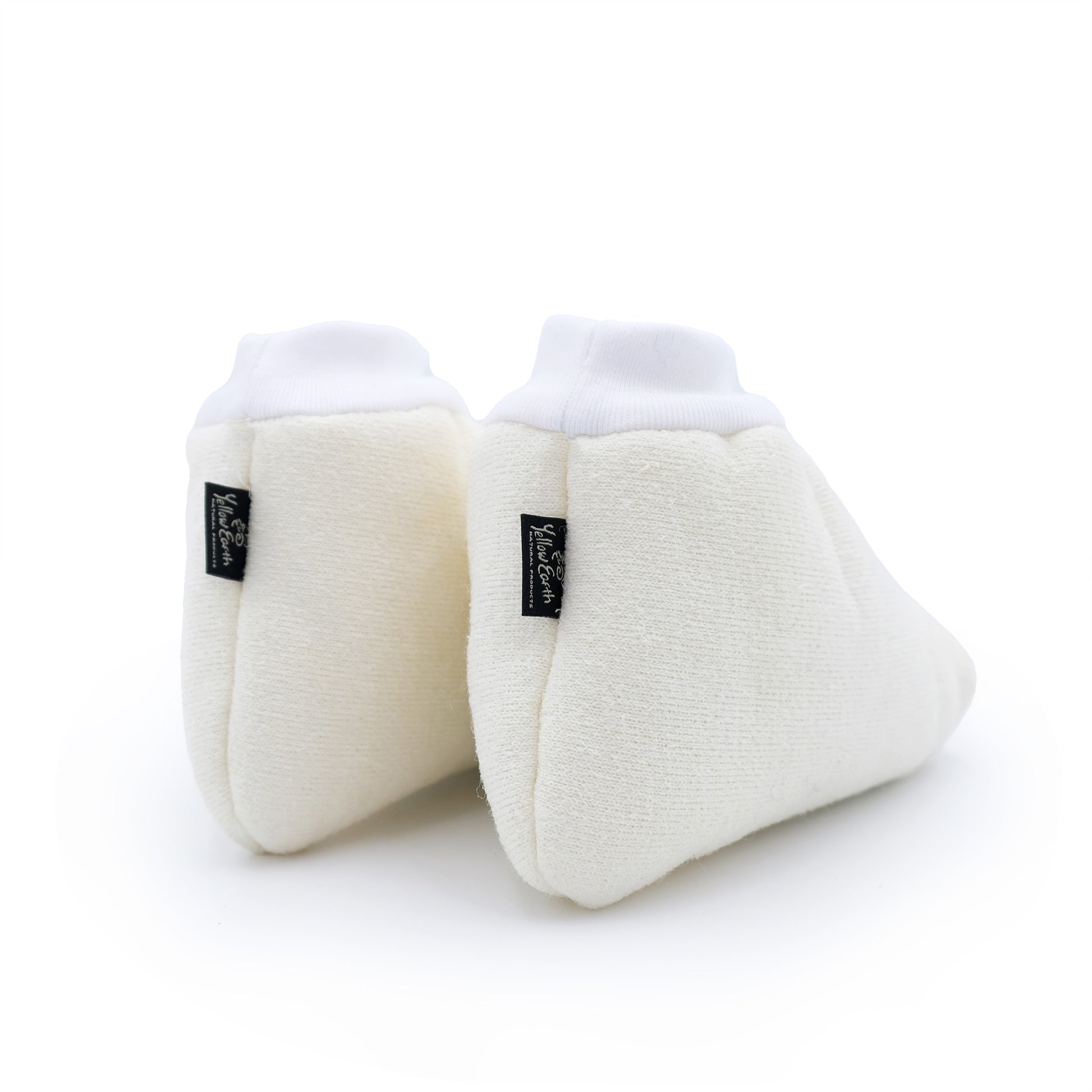Pair of cream sheepskin booties with white ribbed cuffs, angled side view. - Yellow Earth Australia