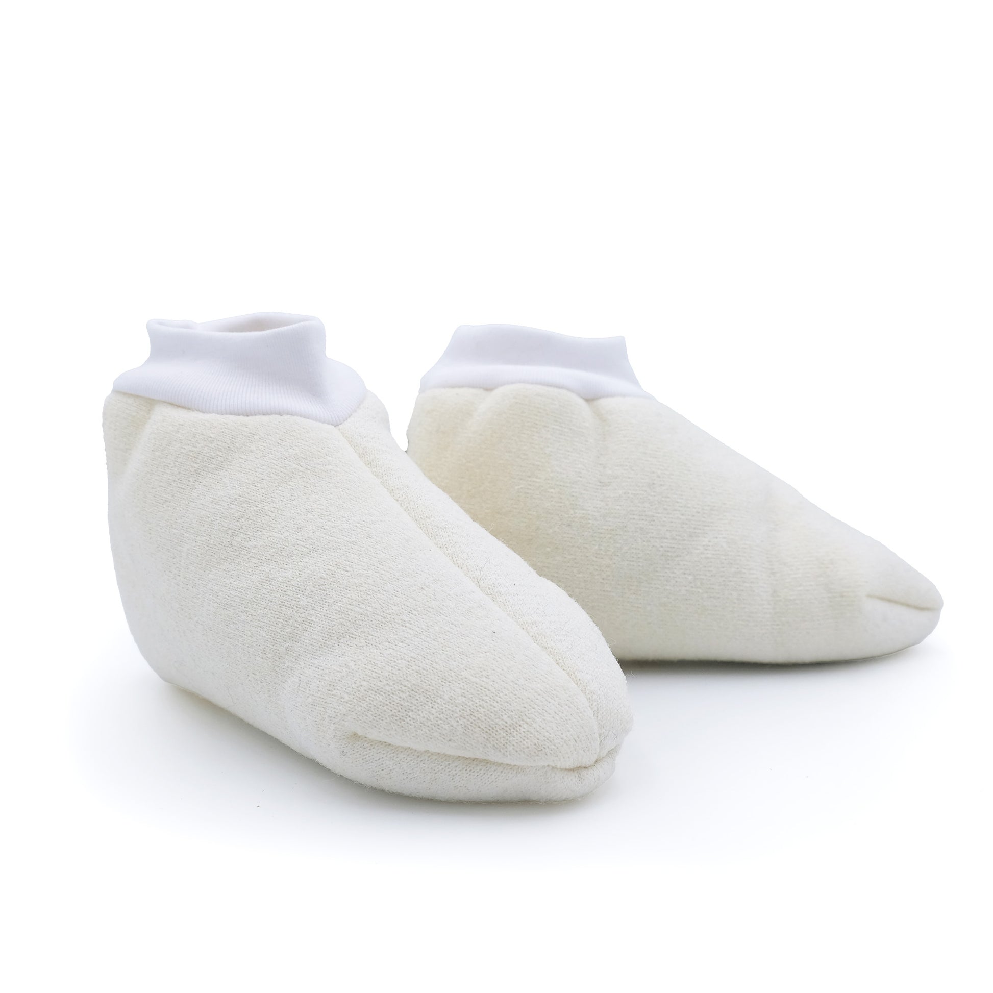 Pair of cream sheepskin booties with white ribbed cuffs, shown from front angle. - Yellow Earth Australia
