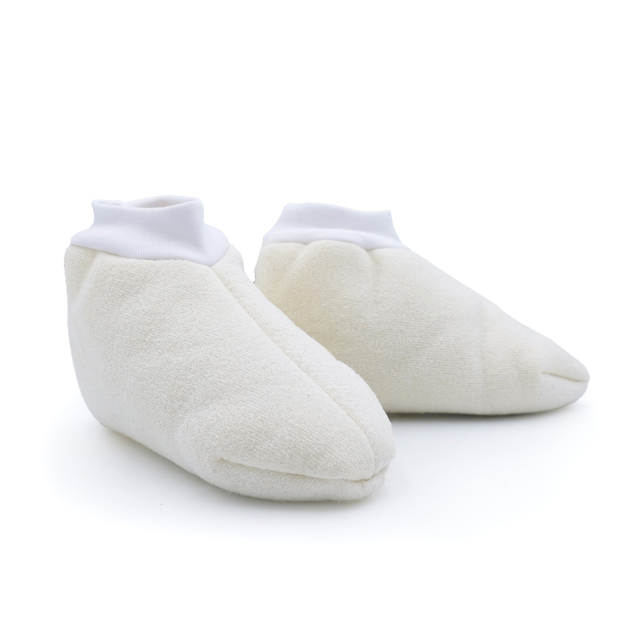 Pair of cream sheepskin booties with white ribbed cuffs, shown from front angle. - Yellow Earth Australia