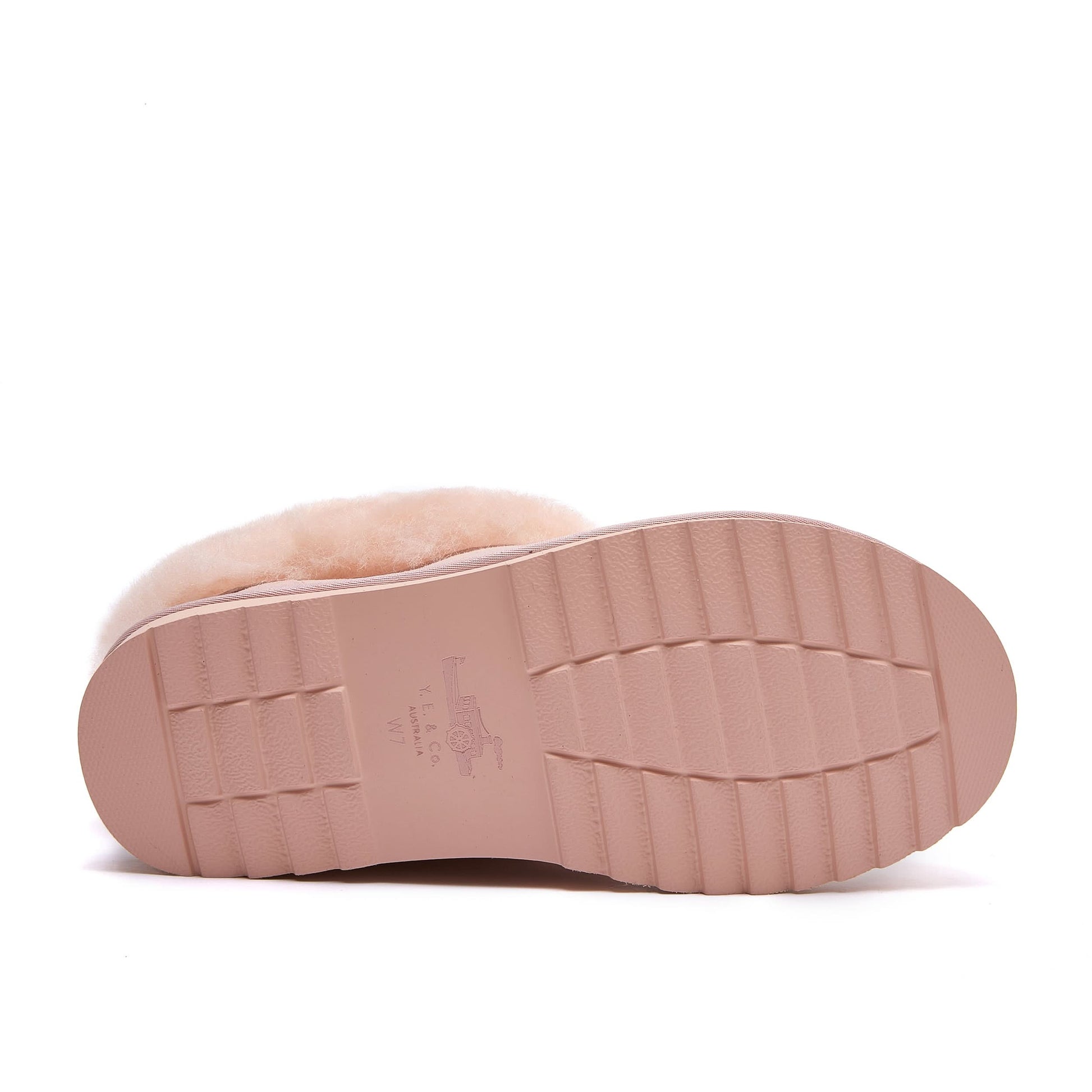 Pink sheepskin slipper sole view showing textured rubber outsole. - Yellow Earth Australia