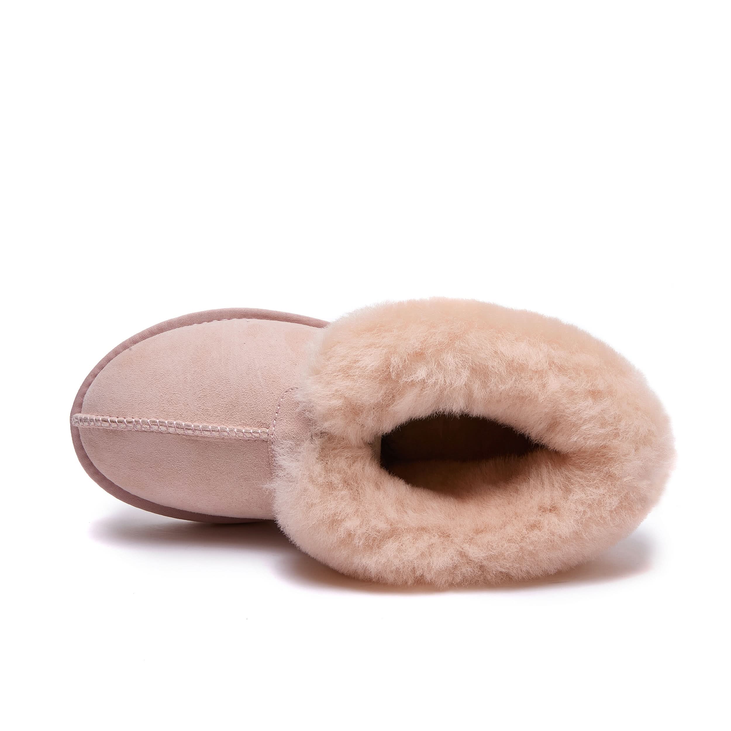 Pink sheepskin slipper with wool lining, top view showing sole and fuzzy interior. - Yellow Earth Australia