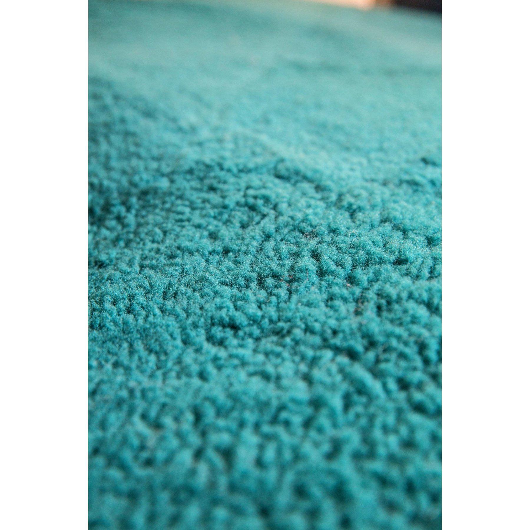 Close-up of turquoise wool carpet texture showing soft pile fibers from above. - Yellow Earth Australia