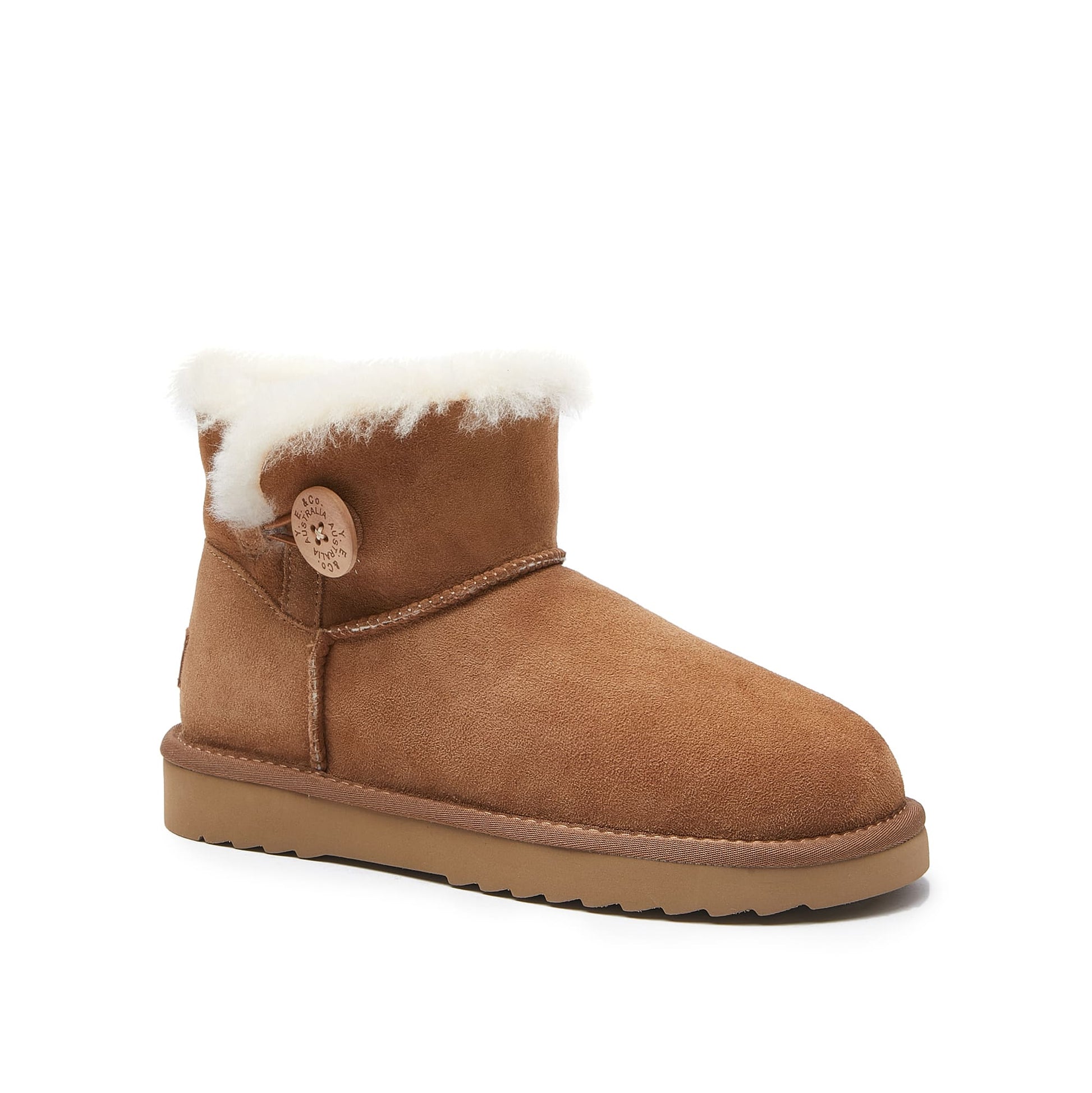 Chestnut sheepskin mini boot with white fur trim and decorative button, side view. - Yellow Earth Australia