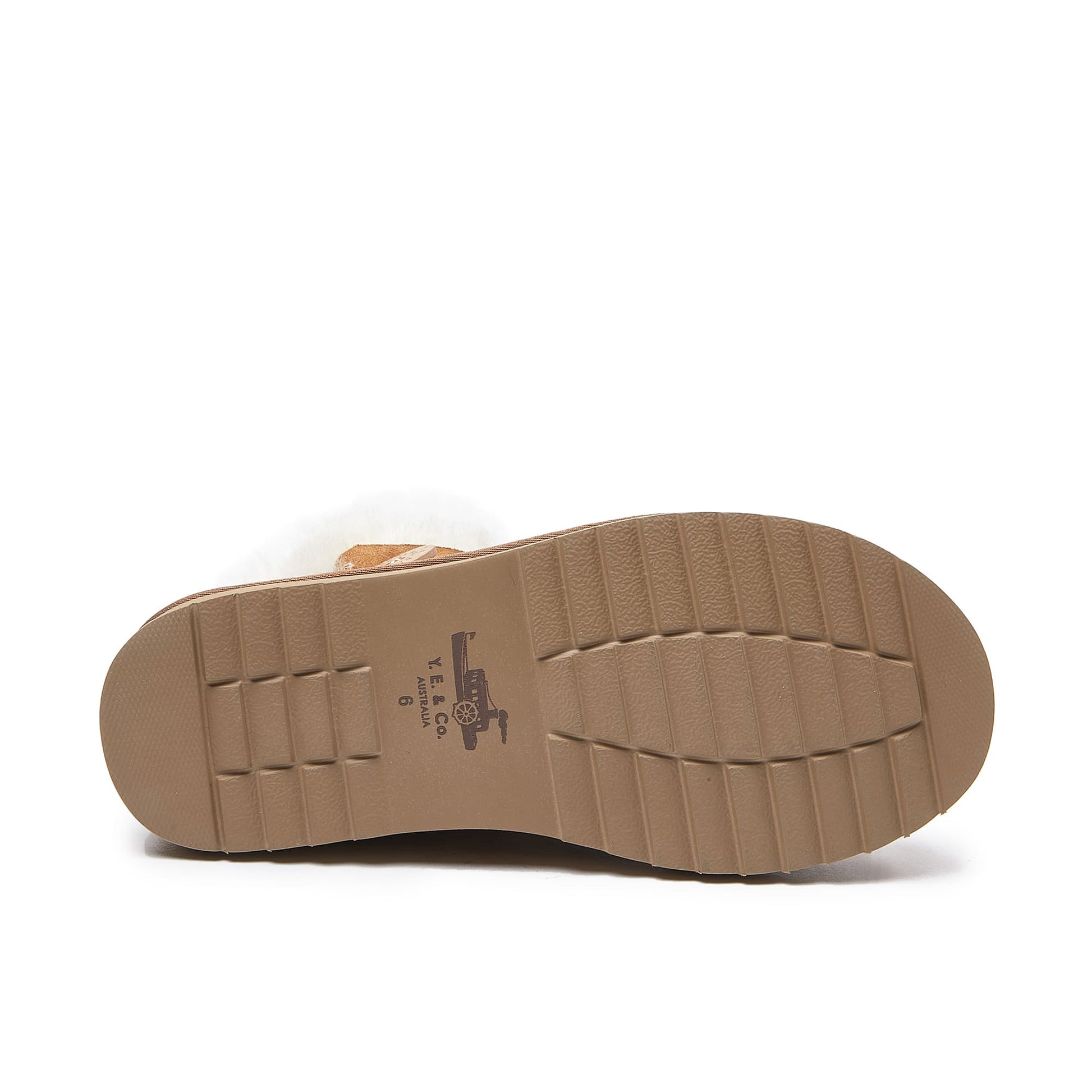 Tan sheepskin boot sole showing textured rubber tread pattern from underside view. - Yellow Earth Australia