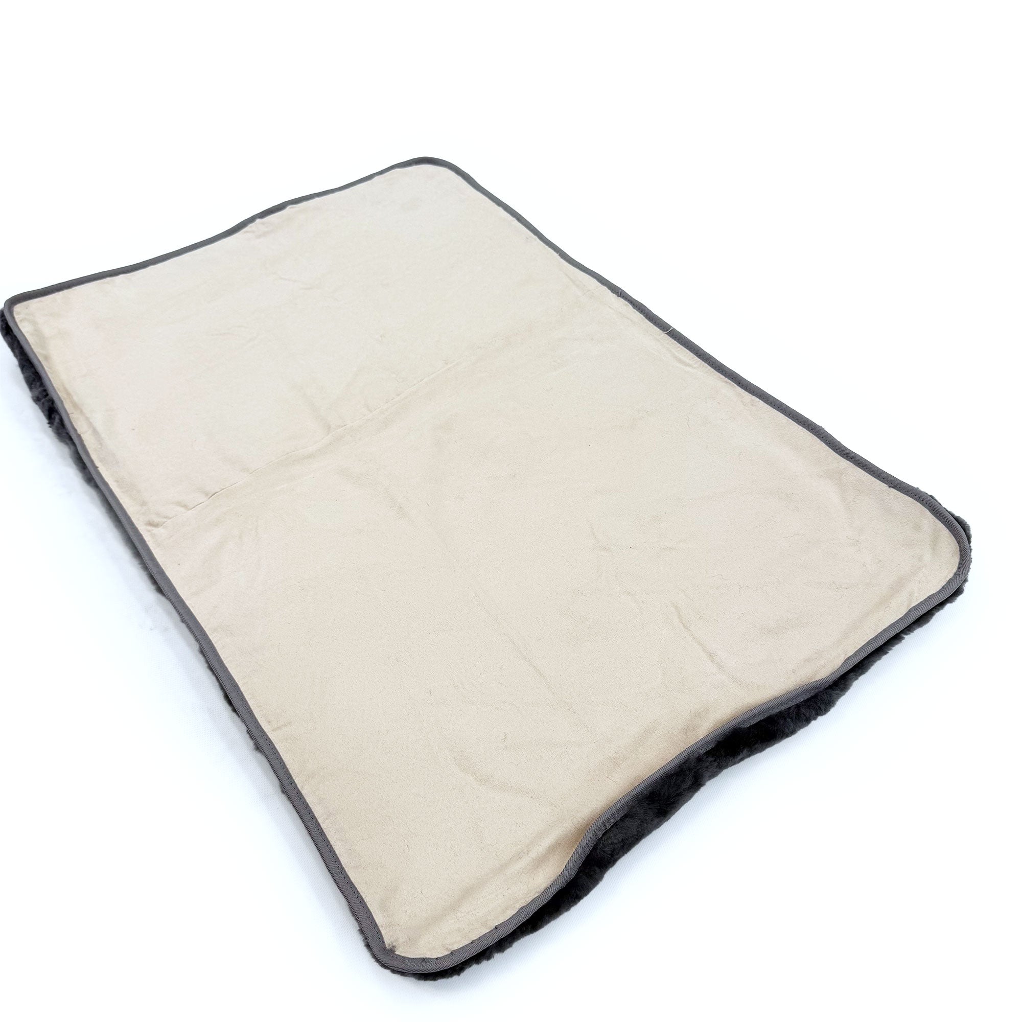 Cream sheepskin pet bed with charcoal grey binding, top view on white background. - Yellow Earth Australia