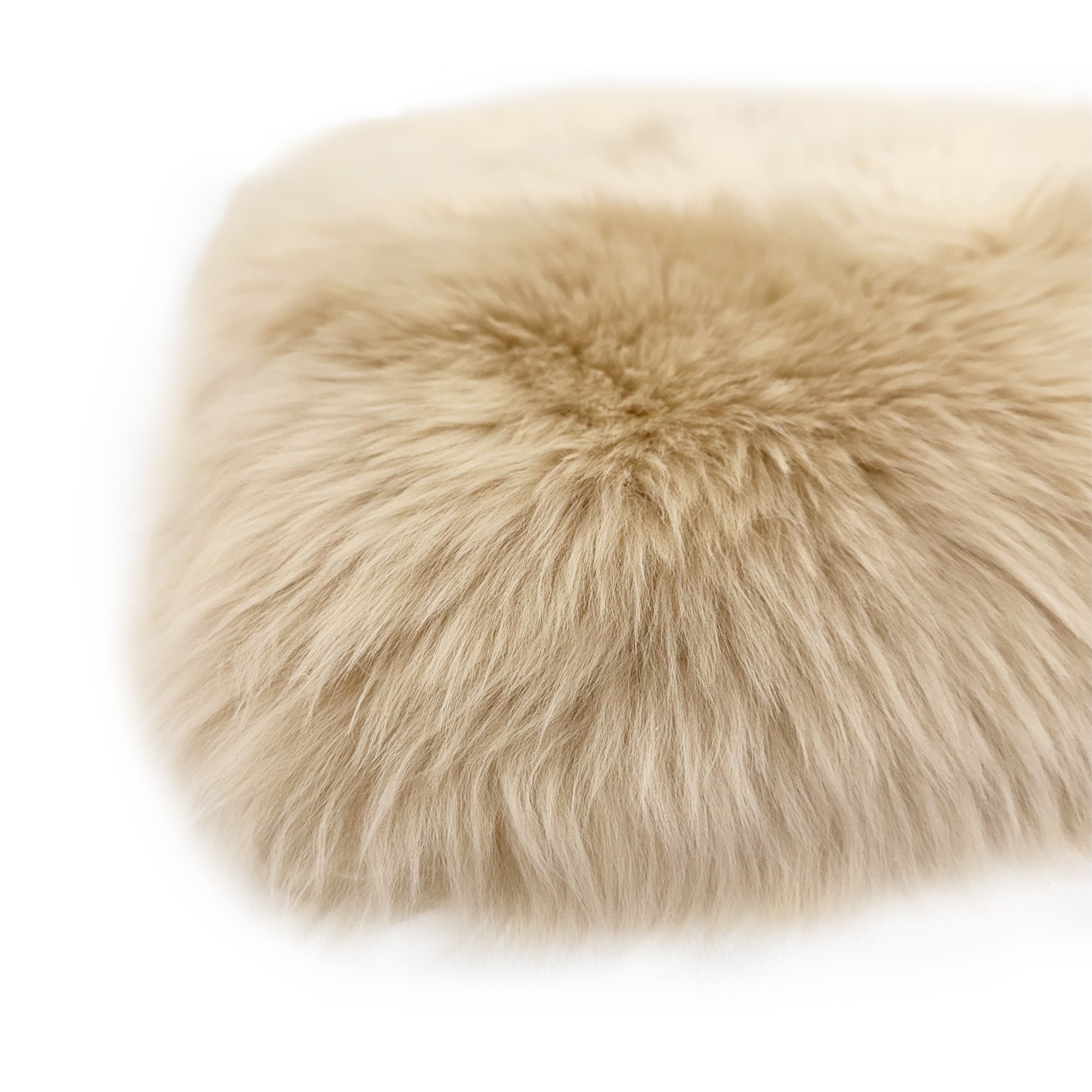 Cream sheepskin pouffe with fluffy wool texture, top view angle. - Yellow Earth Australia
