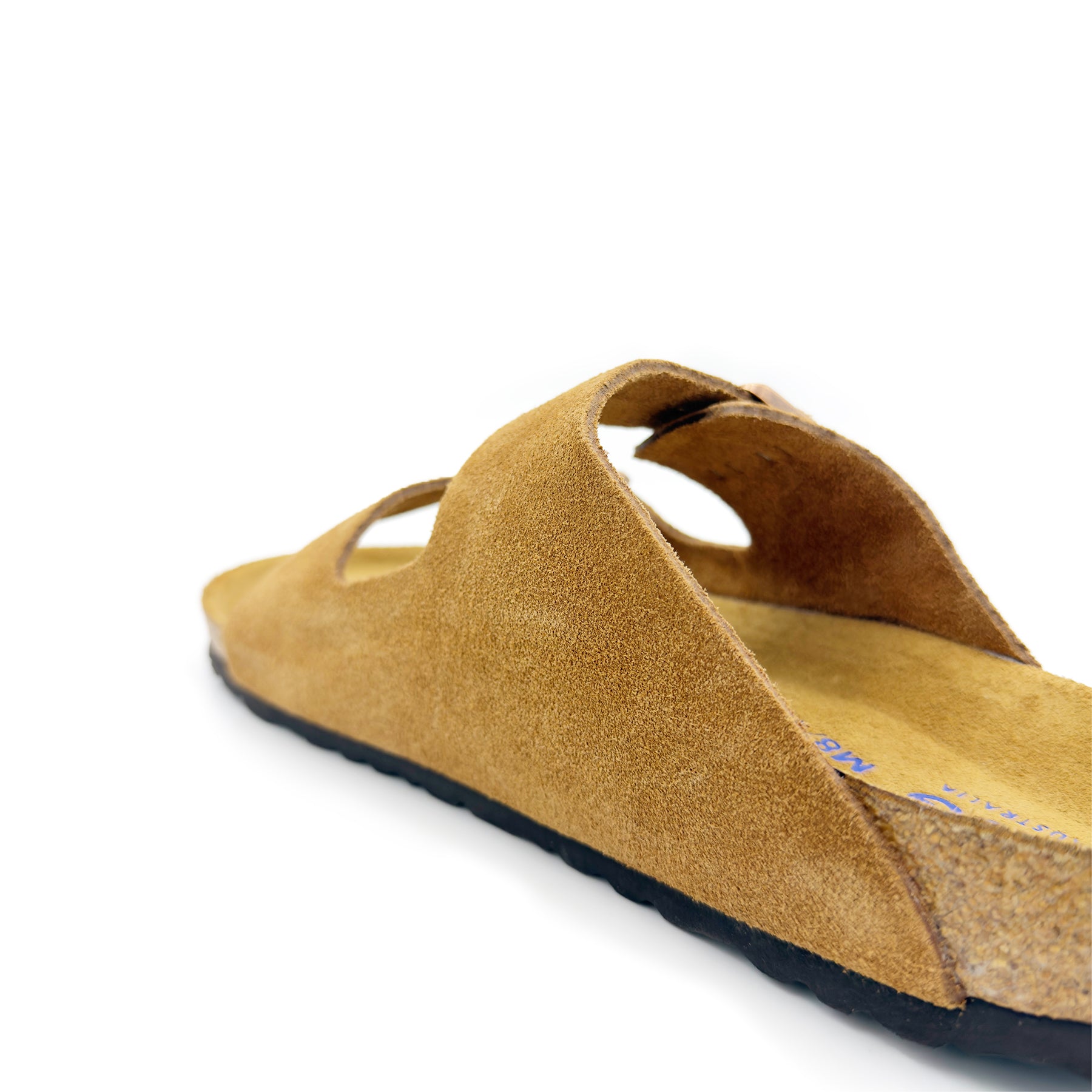 Tan suede slip-on sandal with sheepskin footbed, angled side view. - Yellow Earth Australia