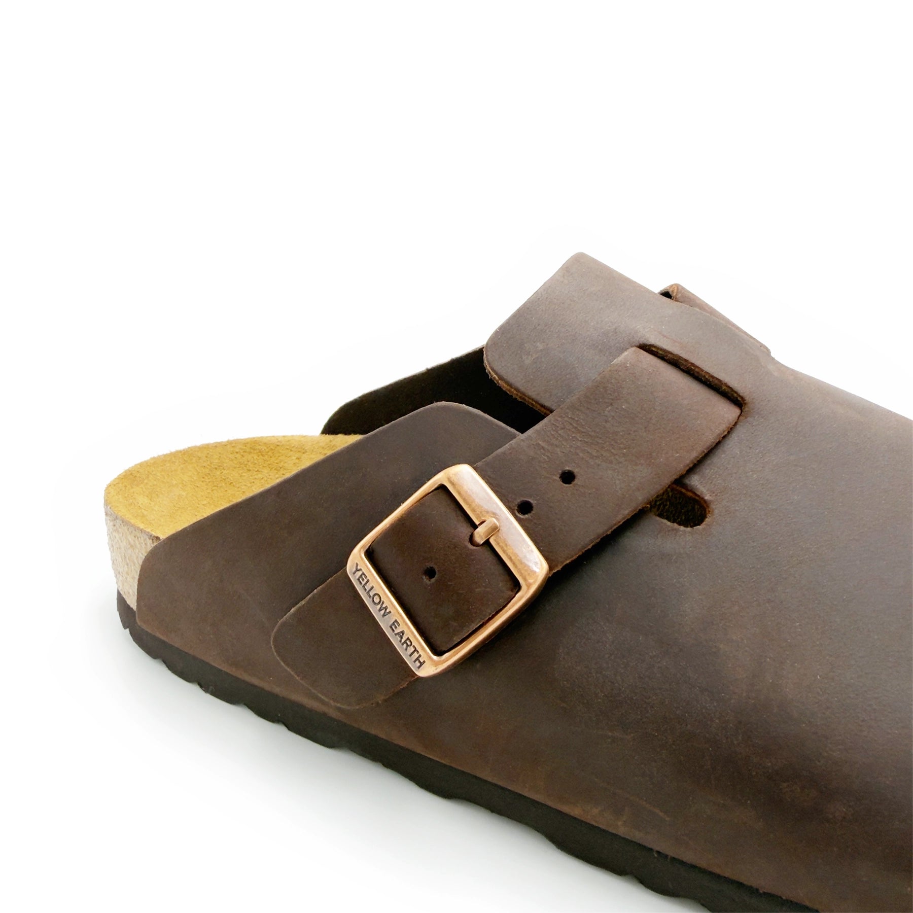 Brown leather clog with buckle strap and sheepskin lining, side angle view. - Yellow Earth Australia