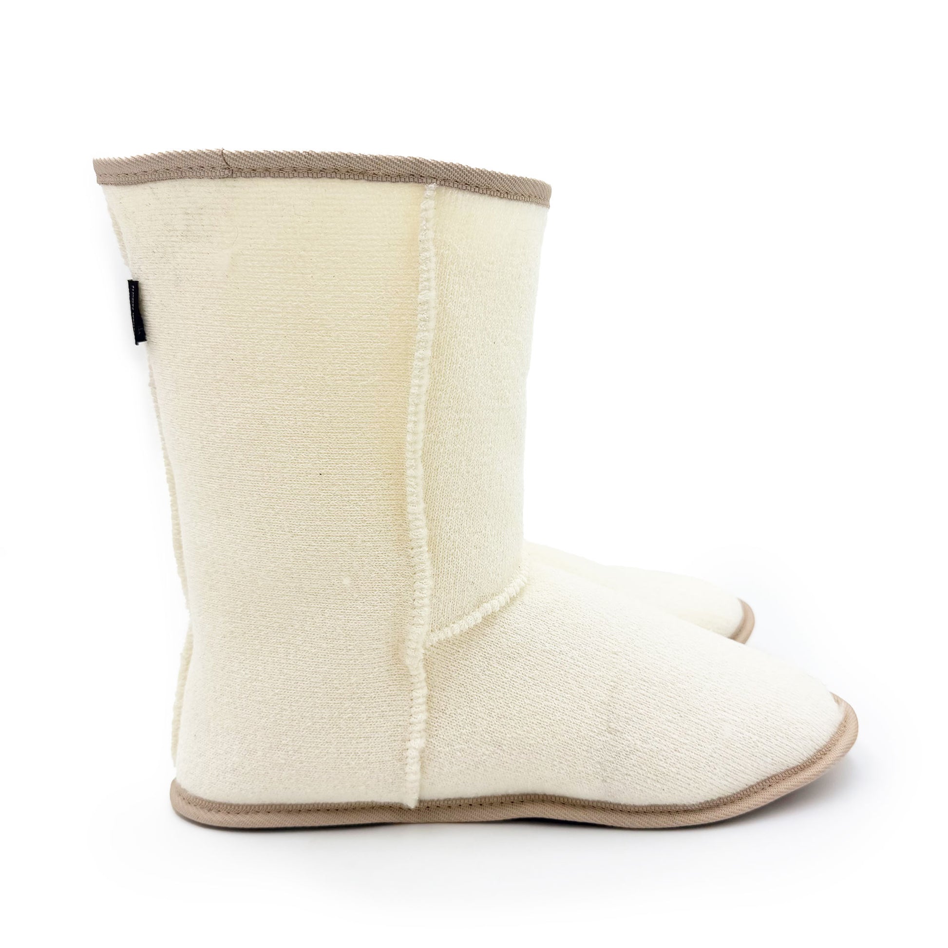 Cream wool sheepskin slipper boot shown from the side view with tan trim. - Yellow Earth Australia
