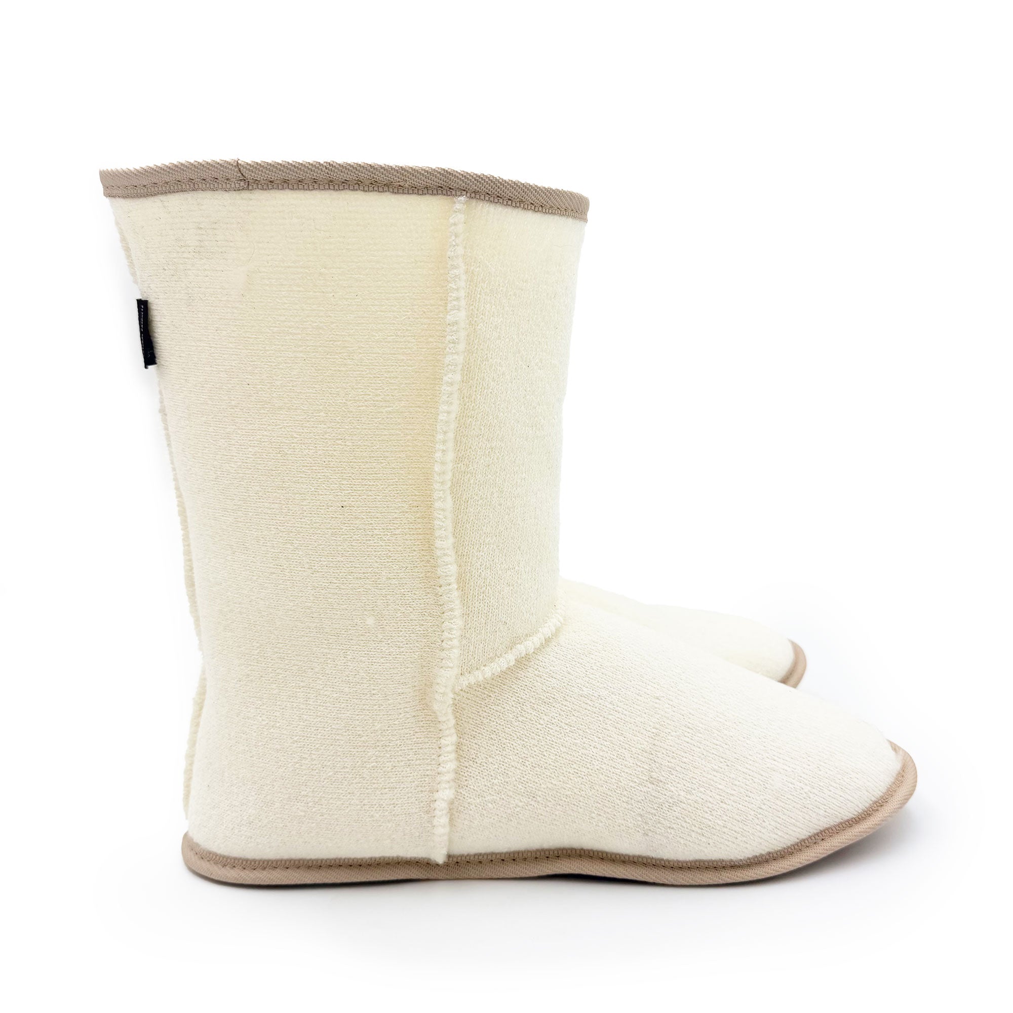 Cream wool sheepskin slipper boot shown from the side view with tan trim. - Yellow Earth Australia