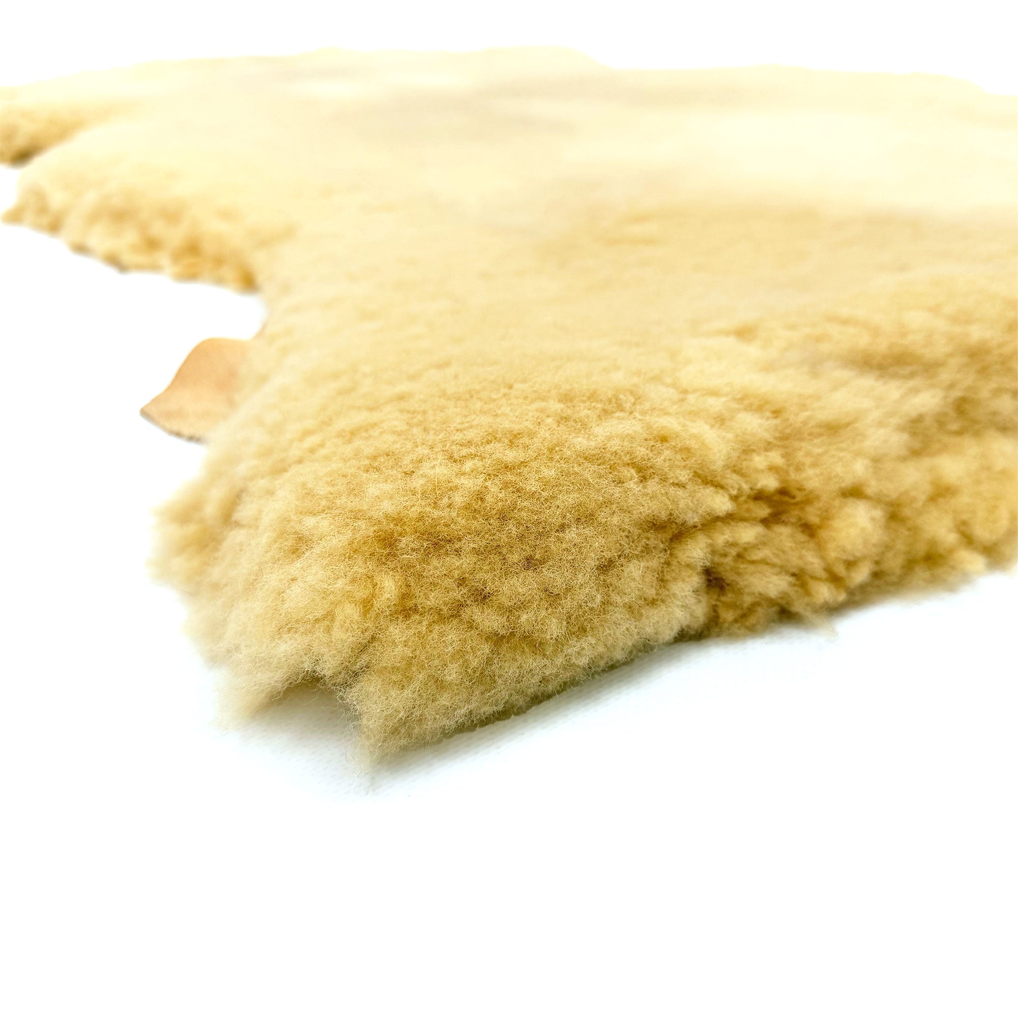 Cream sheepskin rug showing soft wool texture from close-up side angle. - Yellow Earth Australia