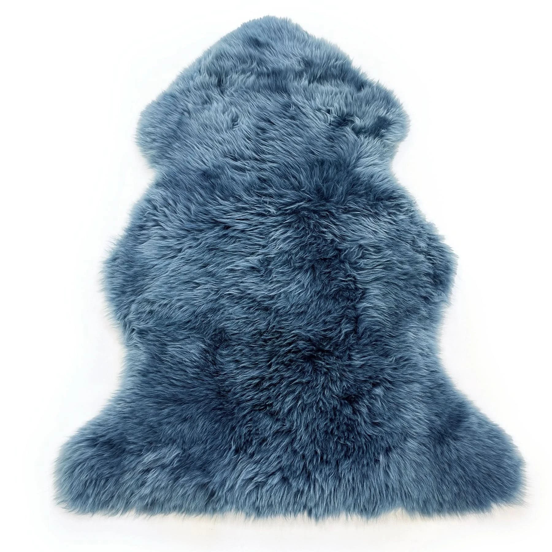 Blue sheepskin rug with thick wool pile viewed from above on white background. - Yellow Earth Australia