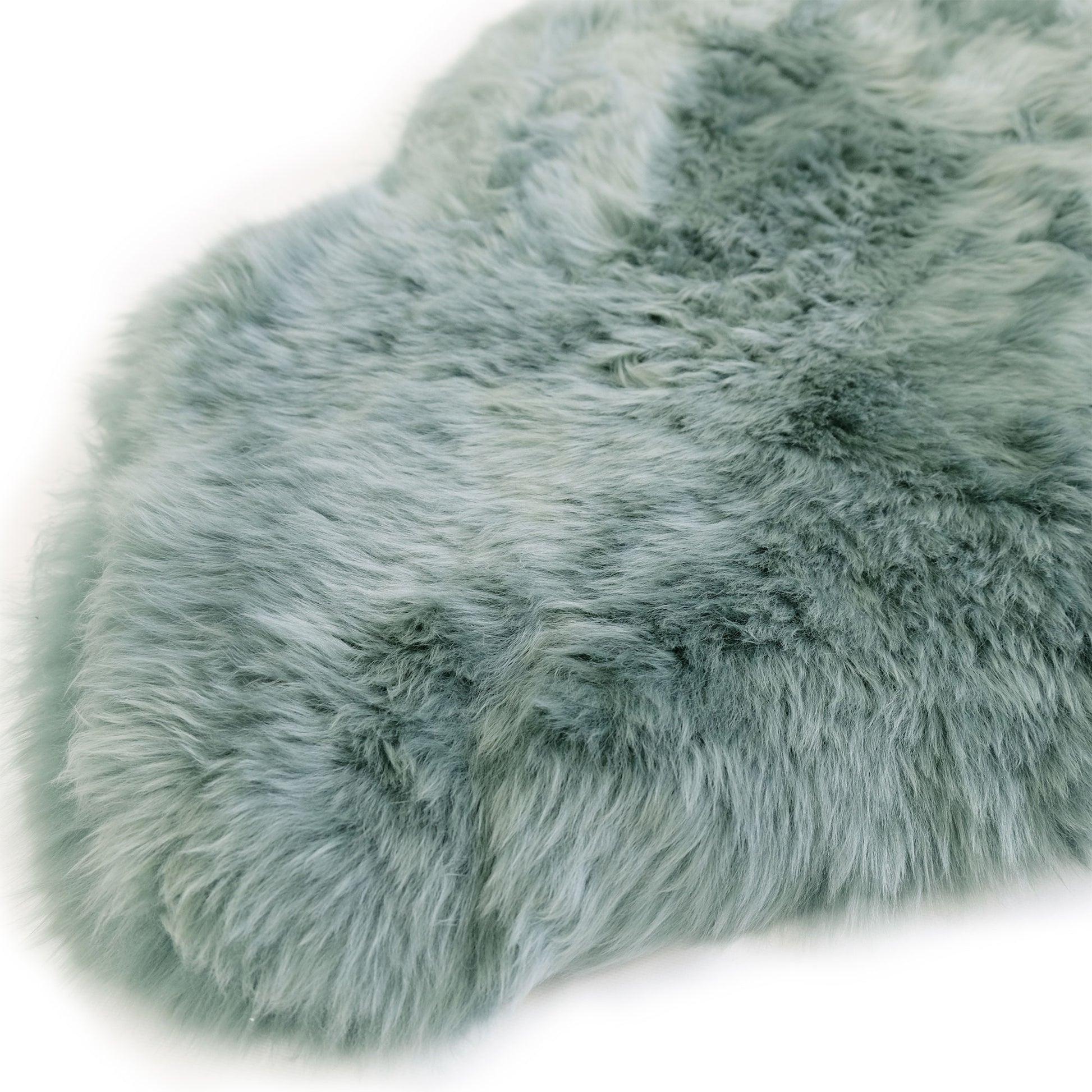 Soft sage green sheepskin rug with luxurious wool pile, top-down view. - Yellow Earth Australia