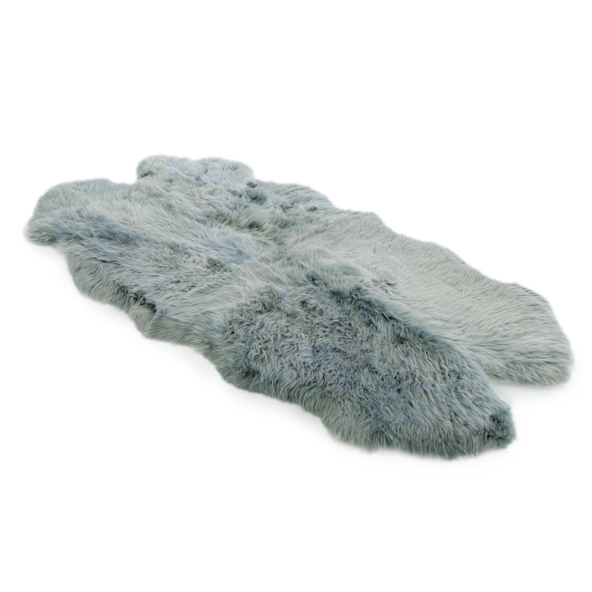 Grey sheepskin rug with natural wool texture, viewed from above on white background. - Yellow Earth Australia