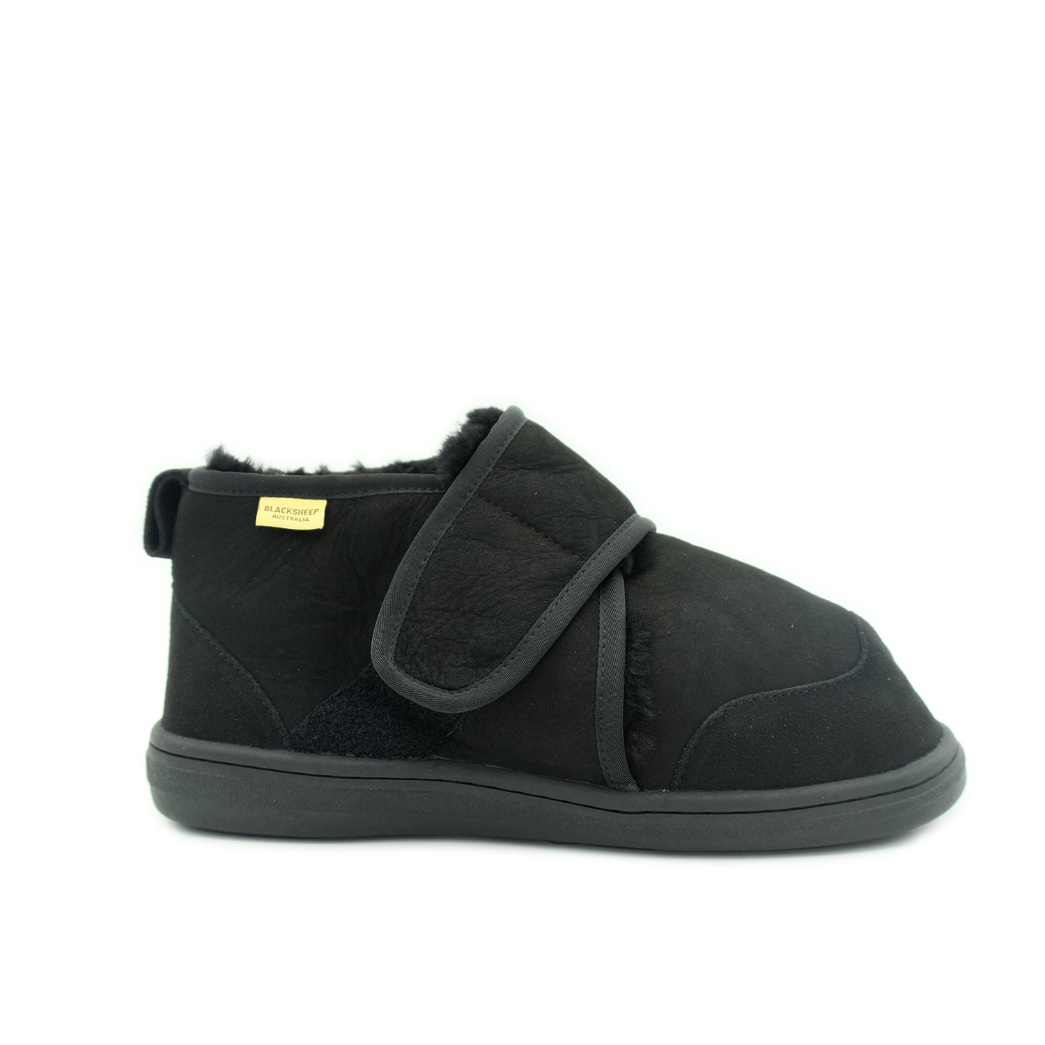 Black sheepskin bootie slipper with adjustable strap, side view. - Yellow Earth Australia