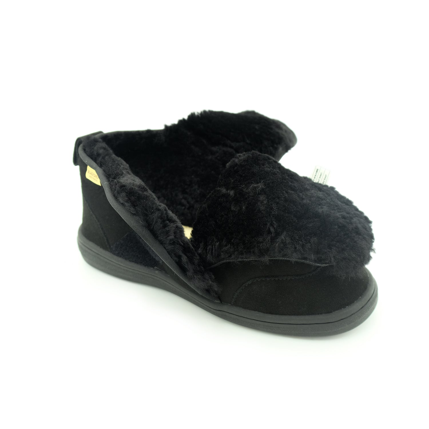 Black sheepskin bootie slipper with fluffy wool lining, side view. - Yellow Earth Australia