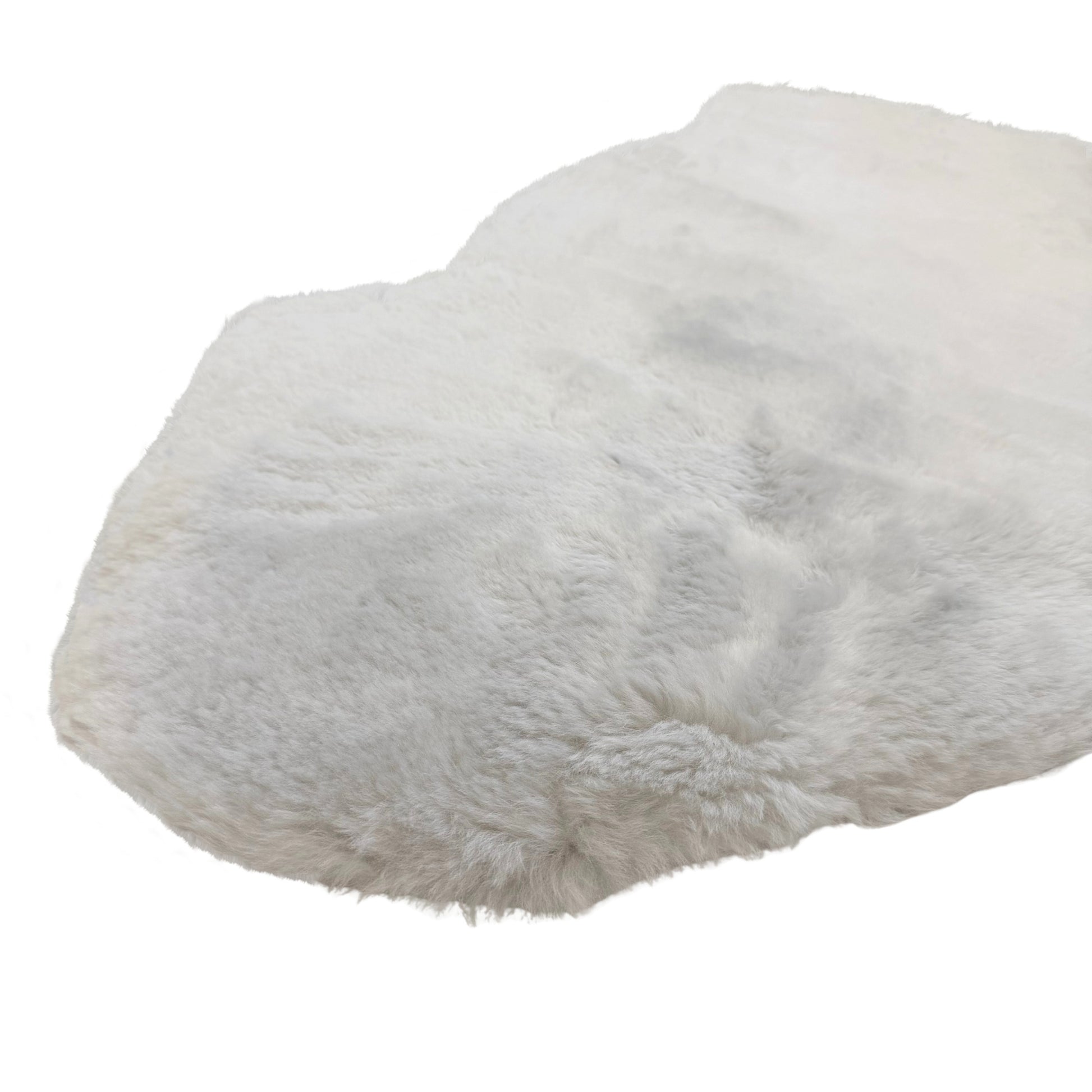 White sheepskin rug with soft woolly texture, top-down angled view. - Yellow Earth Australia