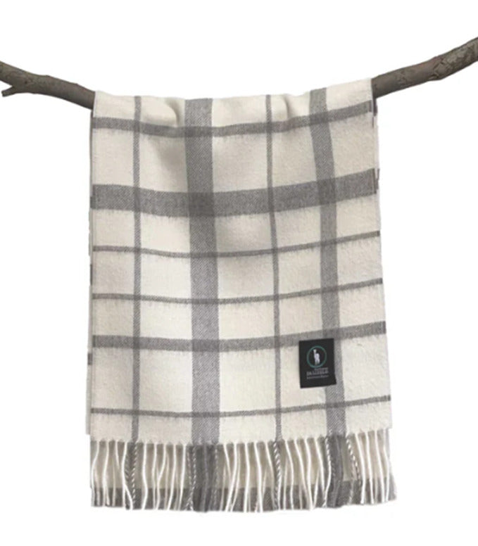 Grey and cream plaid wool throw blanket with fringe displayed on branch. - Yellow Earth Australia
