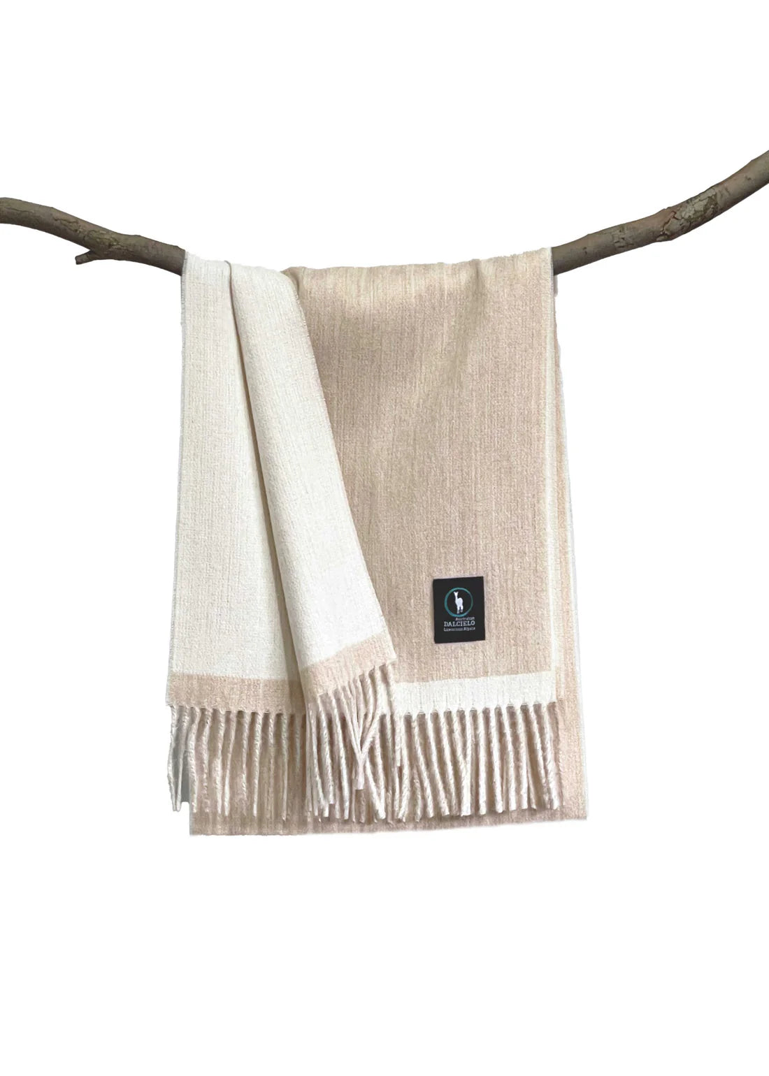Beige wool throw blanket with fringe draped over branch, front view. - Yellow Earth Australia
