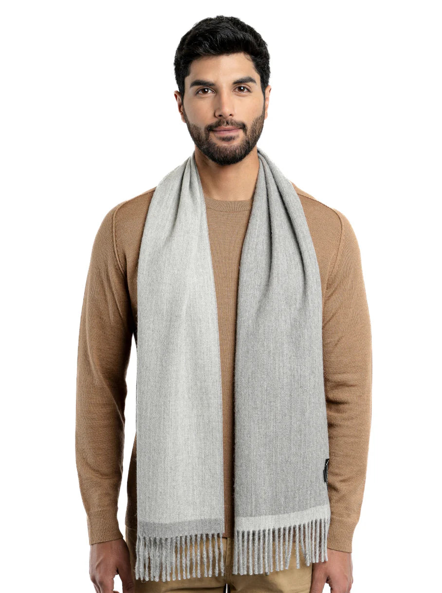 Light grey wool scarf with fringe drape worn over camel sweater, front view. - Yellow Earth Australia