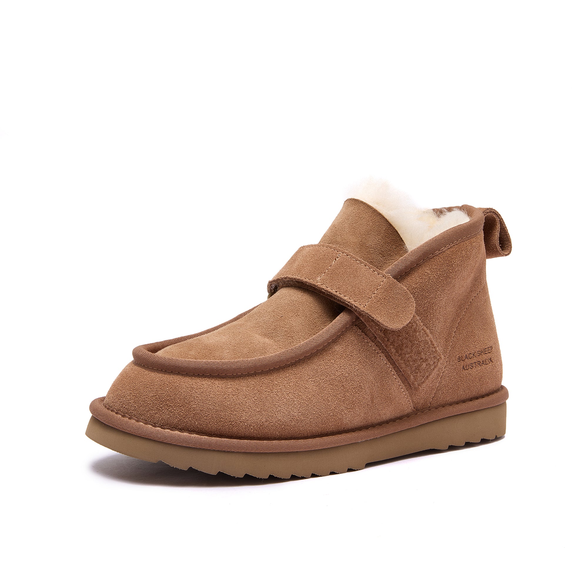 A single brown suede ankle boot with a hook-and-loop strap closure and a soft white shearling lining, shown from a side profile on a white background - Fleece Easy v2 Chestnut
