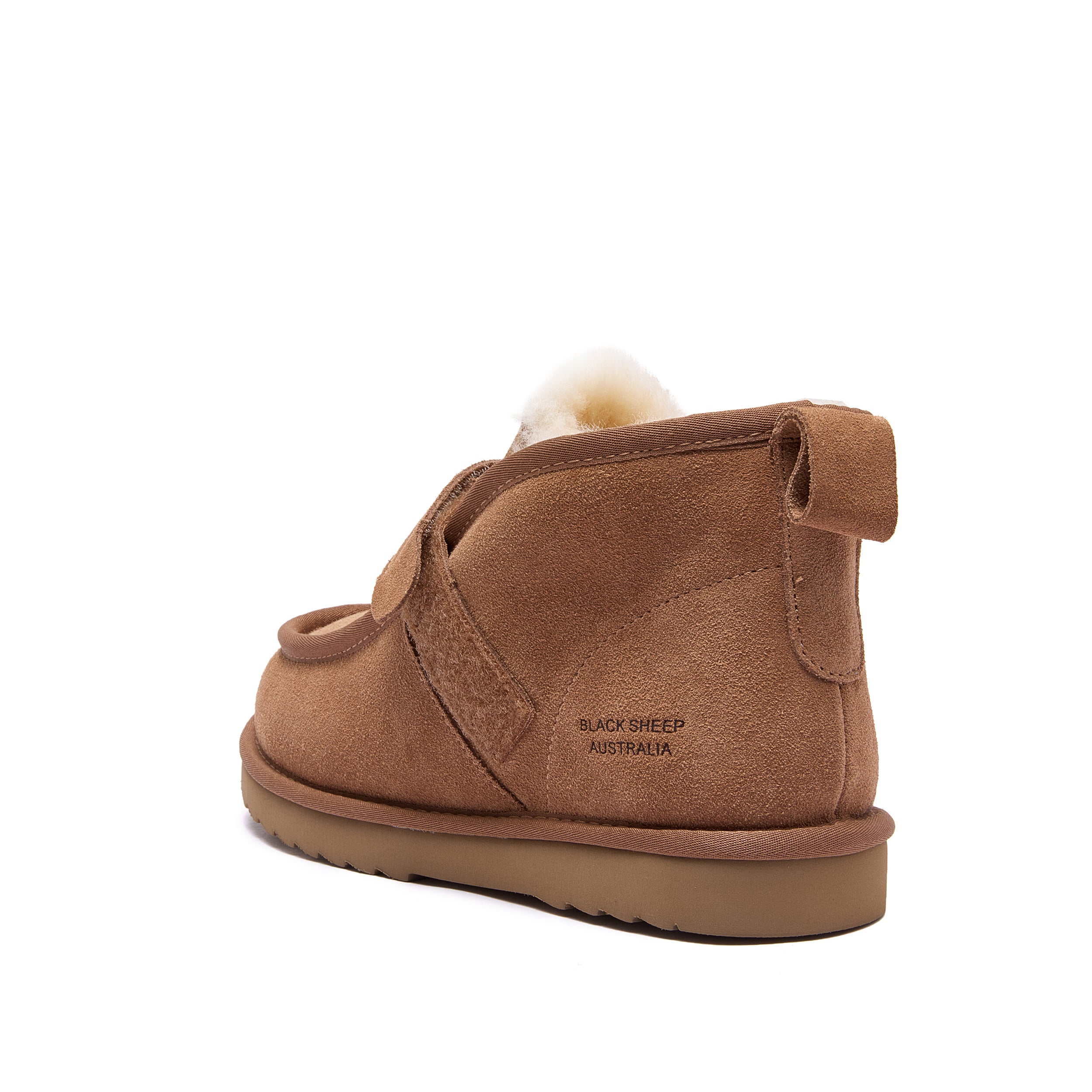 A single brown suede slipper boot with a fluffy cream shearling lining peeking out from the top, shown from a rear three-quarter angle on a white background. The heel has 'BLACK SHEEP AUSTRALIA' printed on it - Fleece Easy v2 Chestnut