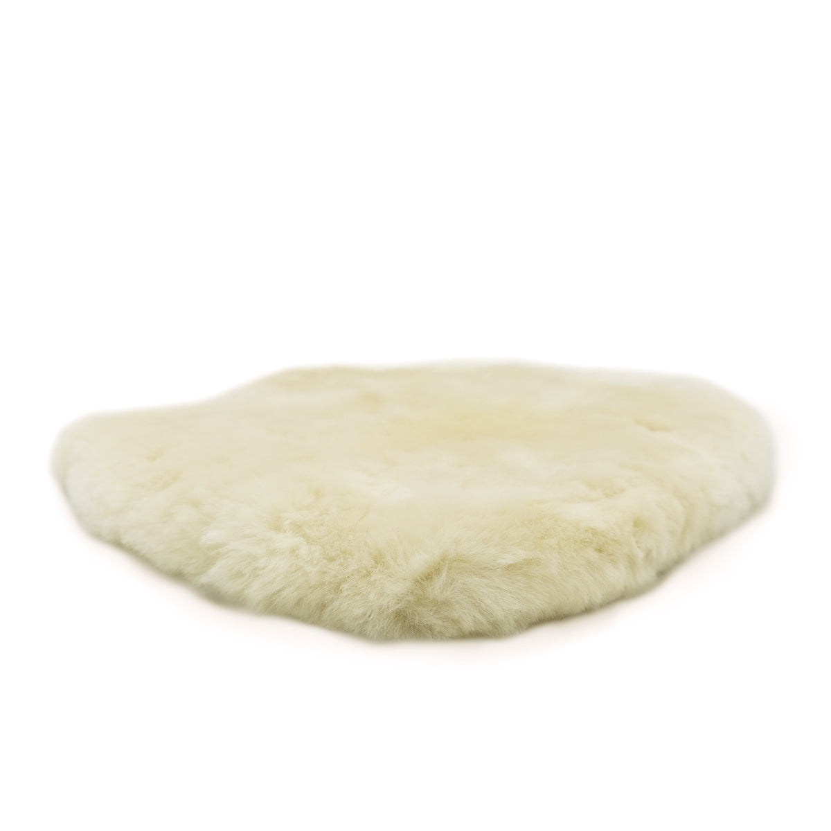 Cream sheepskin rug with soft wool pile, overhead view showing oval shape. - Yellow Earth Australia