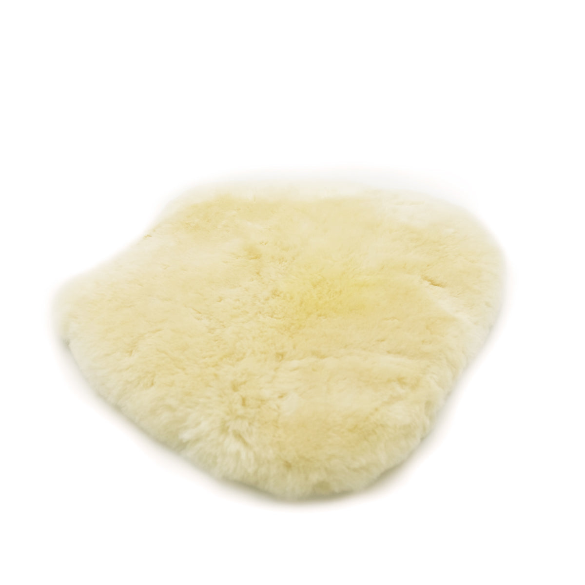 Cream sheepskin wool pelt viewed from above showing soft fluffy texture. - Yellow Earth Australia