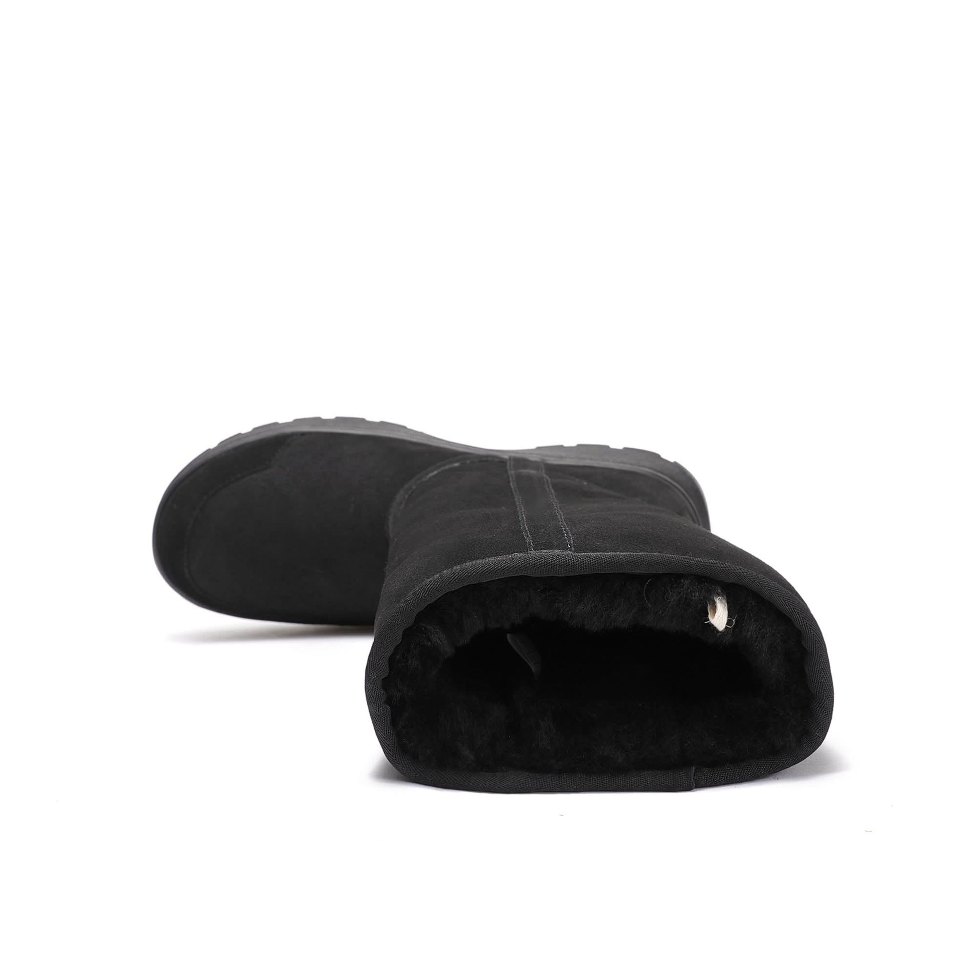 Black sheepskin boots with fluffy wool lining, front angled view. - Yellow Earth Australia
