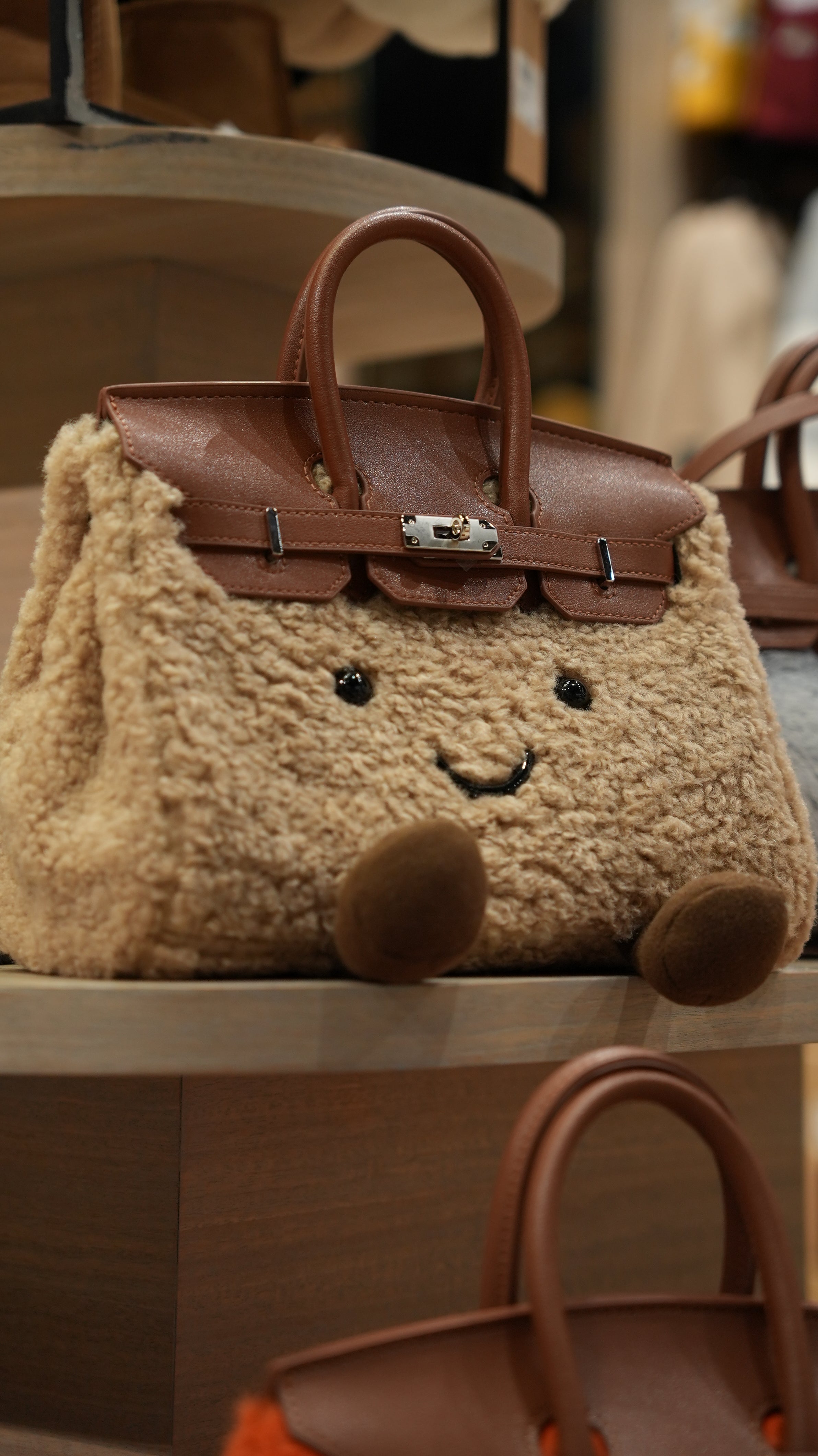 Cute beige sheepskin handbag with brown leather handles and embroidered face detail, front view. - Yellow Earth Australia