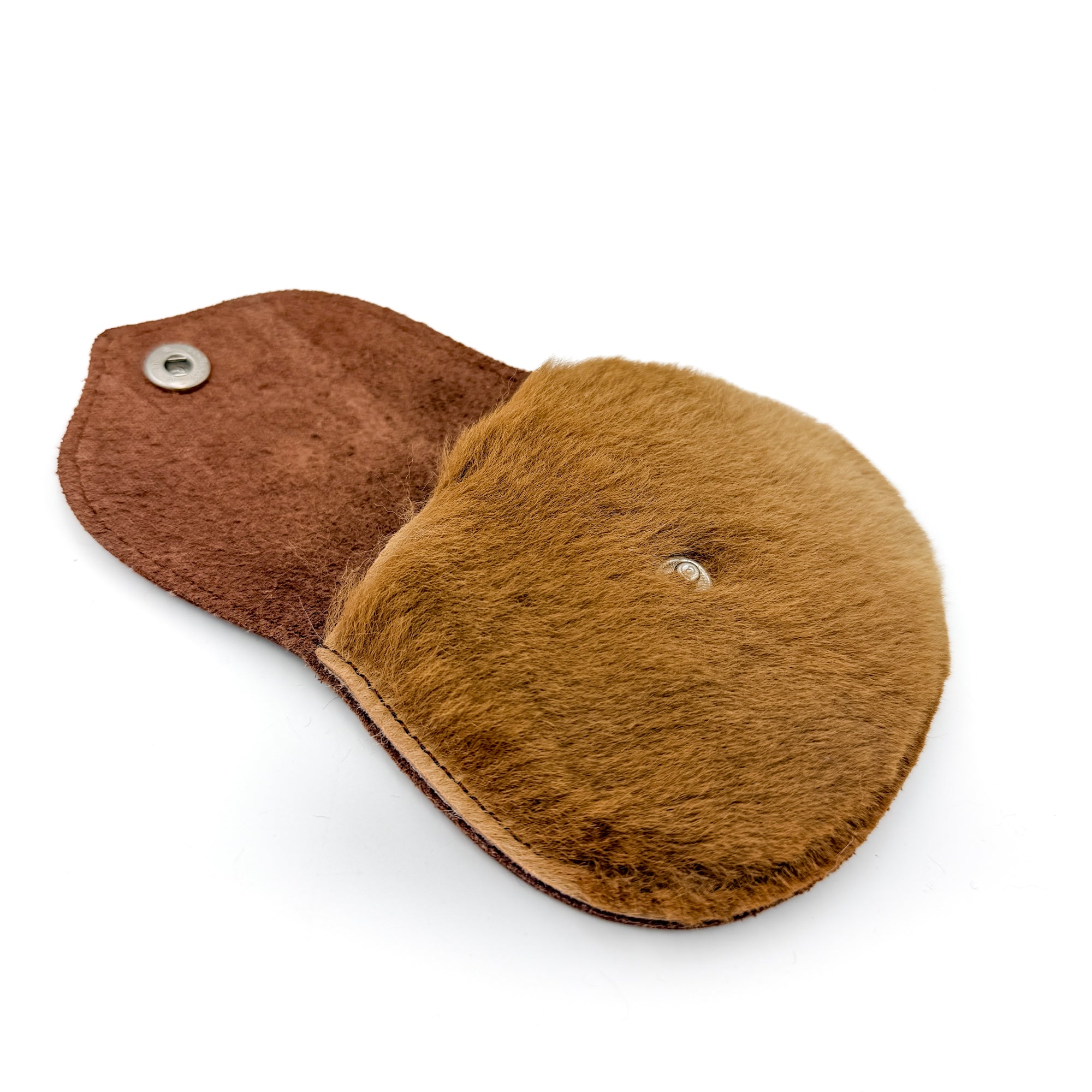 Purse shown open, flap folded back to reveal the fur-lined interior and coin compartment
