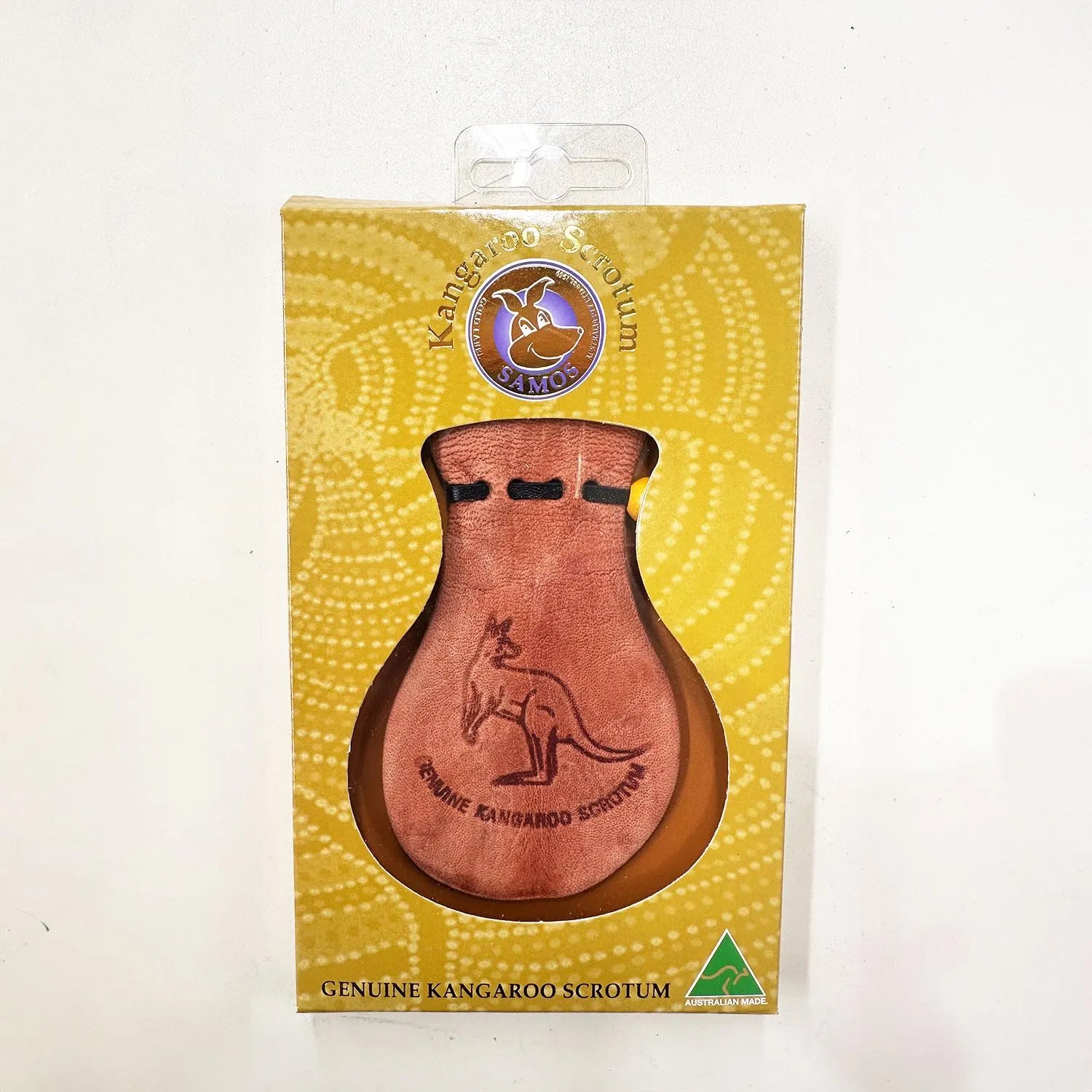 Tan leather kangaroo scrotum keychain with embossed design on yellow packaging. - Yellow Earth Australia