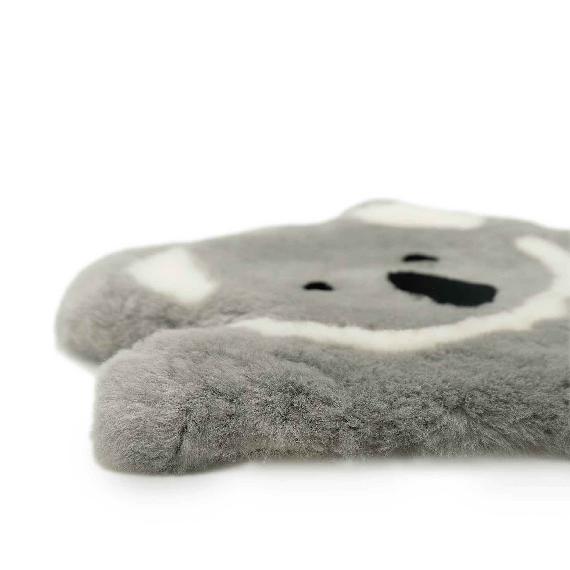 Soft grey and white sheepskin koala-shaped toy viewed from above on white background. - Yellow Earth Australia
