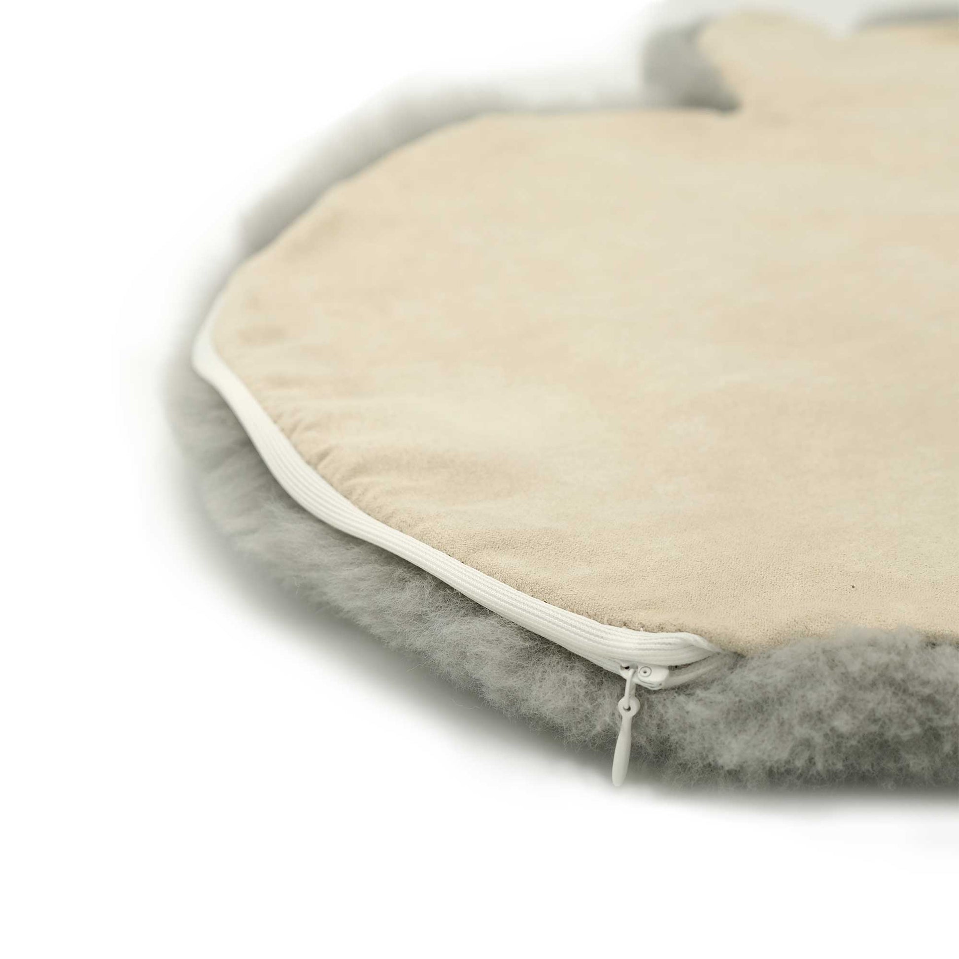 Sheepskin pet bed with cream cover and grey wool base, angled view. - Yellow Earth Australia