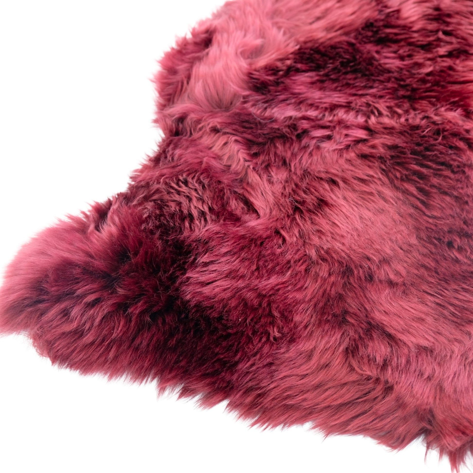 Luxurious pink and burgundy sheepskin rug with soft wool texture, overhead view. - Yellow Earth Australia