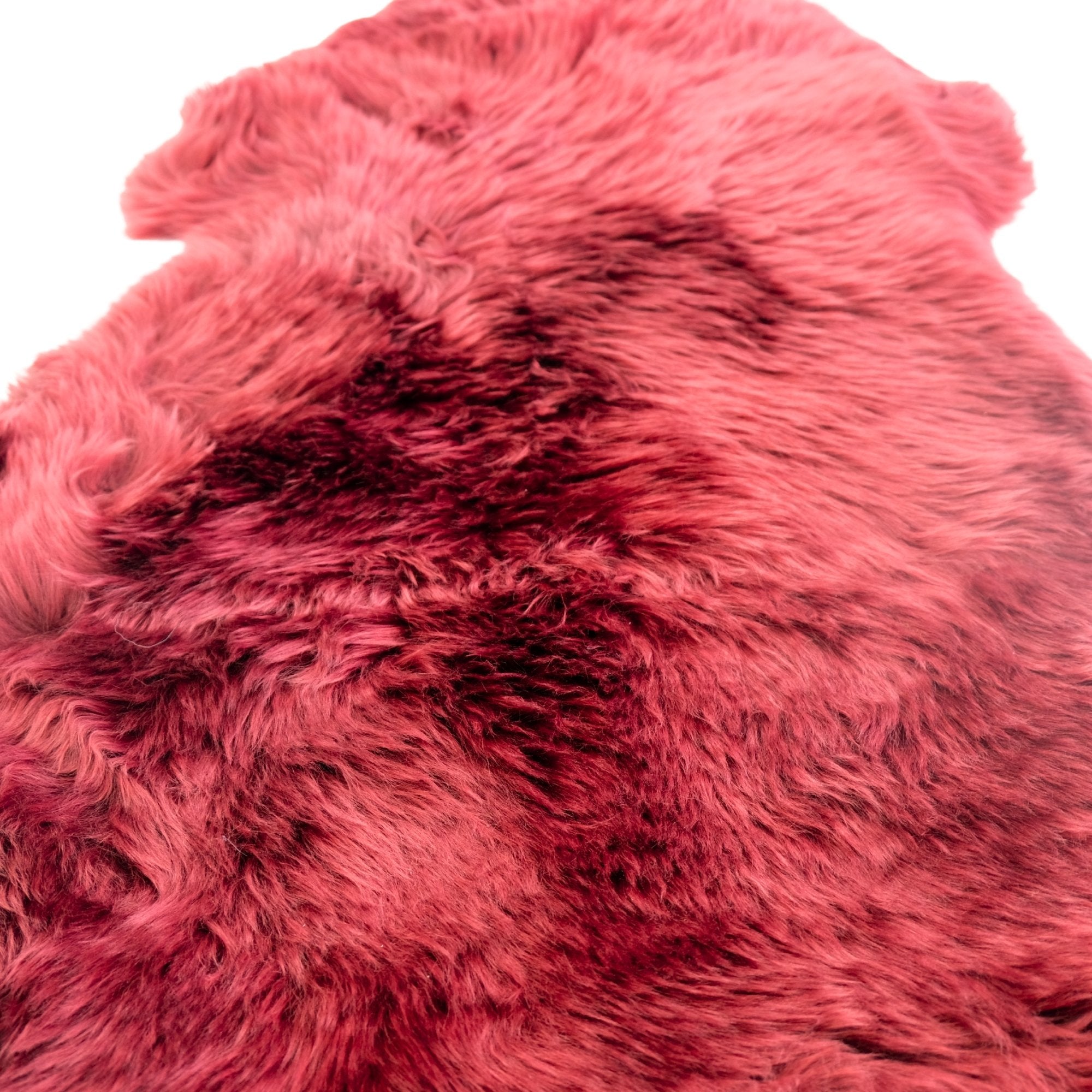 Pink and burgundy ombre sheepskin rug with soft wool texture, top view. - Yellow Earth Australia