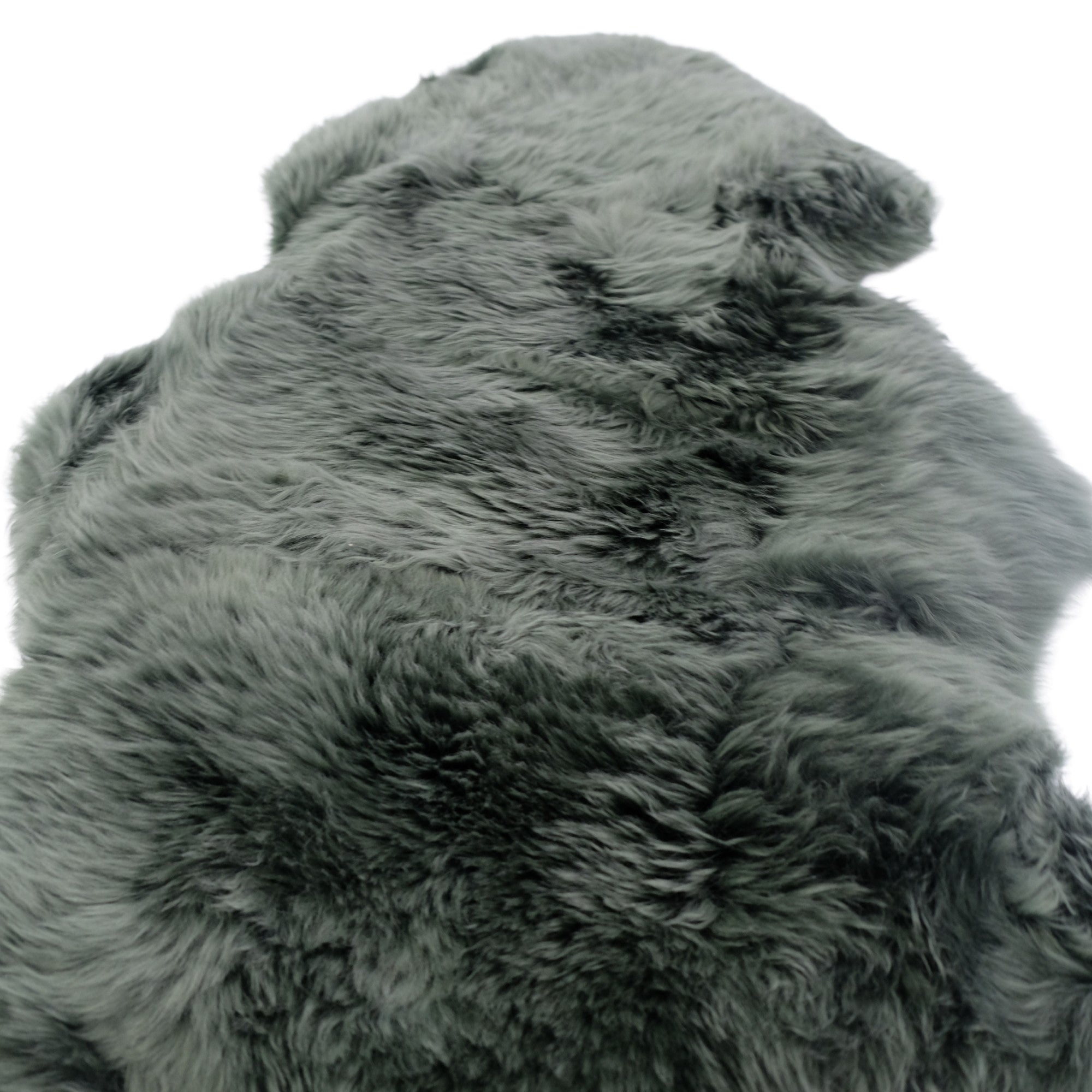 Grey sheepskin rug with luxurious wool pile viewed from above on white background. - Yellow Earth Australia