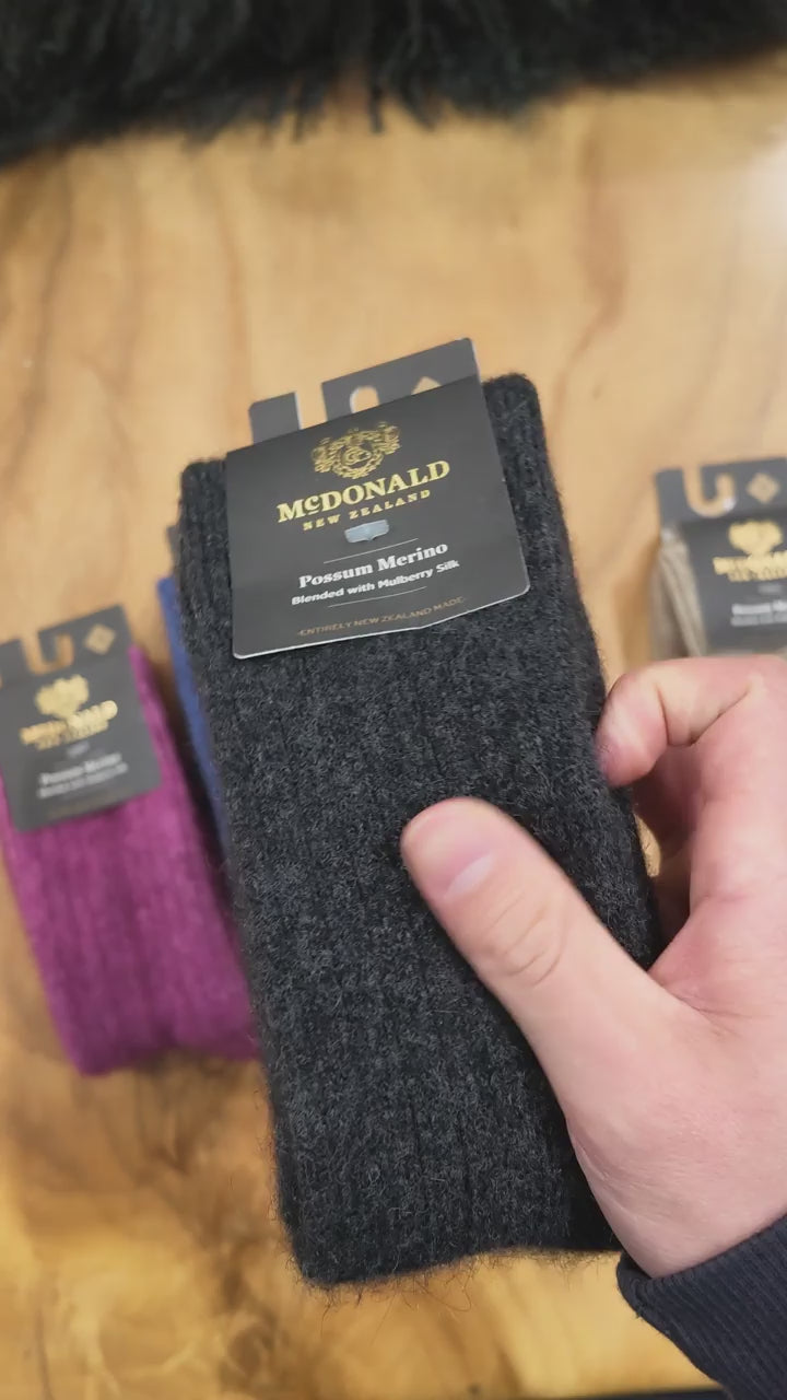 Load video: video close up of the various colours of possum wool socks