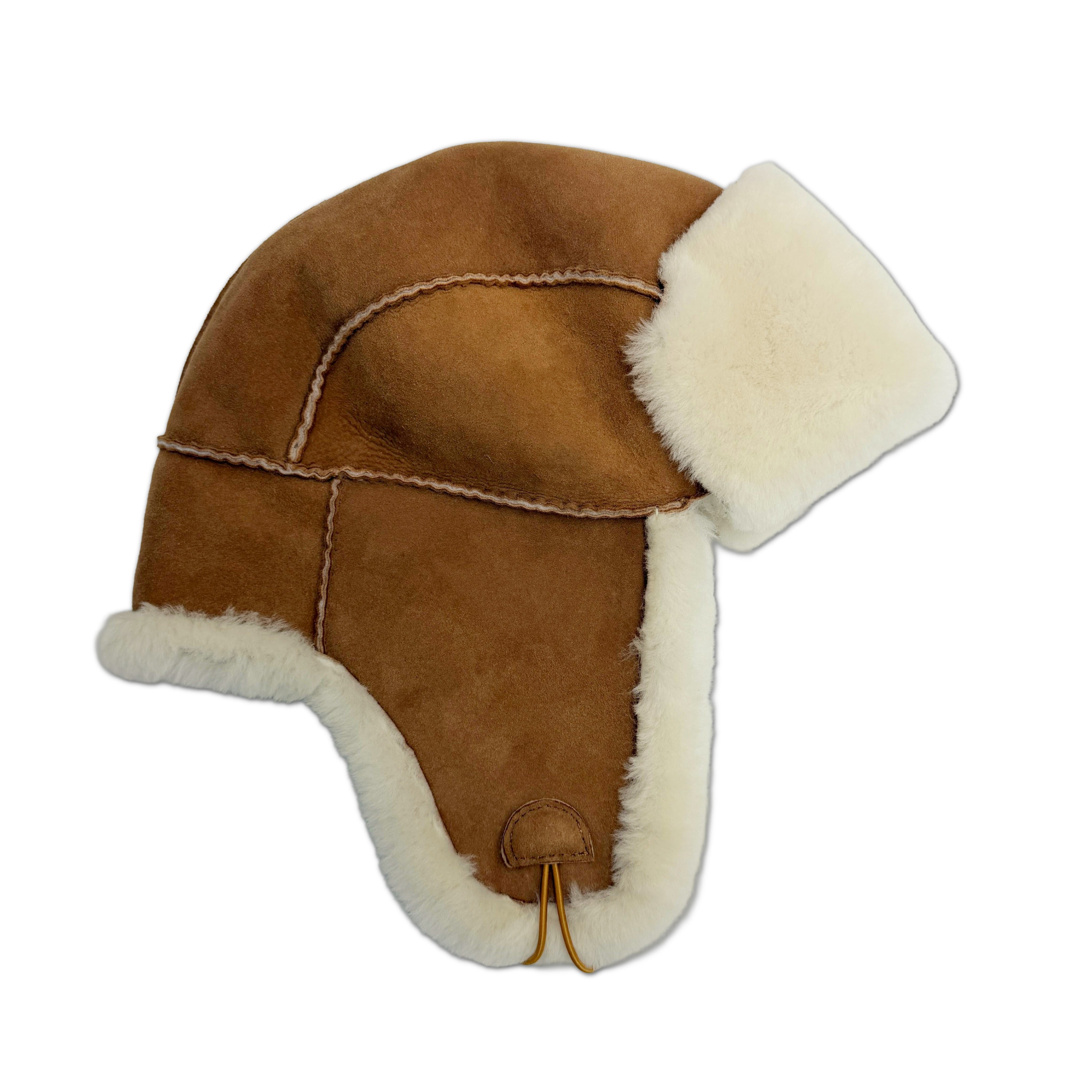 A brown suede aviator-style hat with thick white shearling lining on the ear flaps and crown- Yellow Earth
