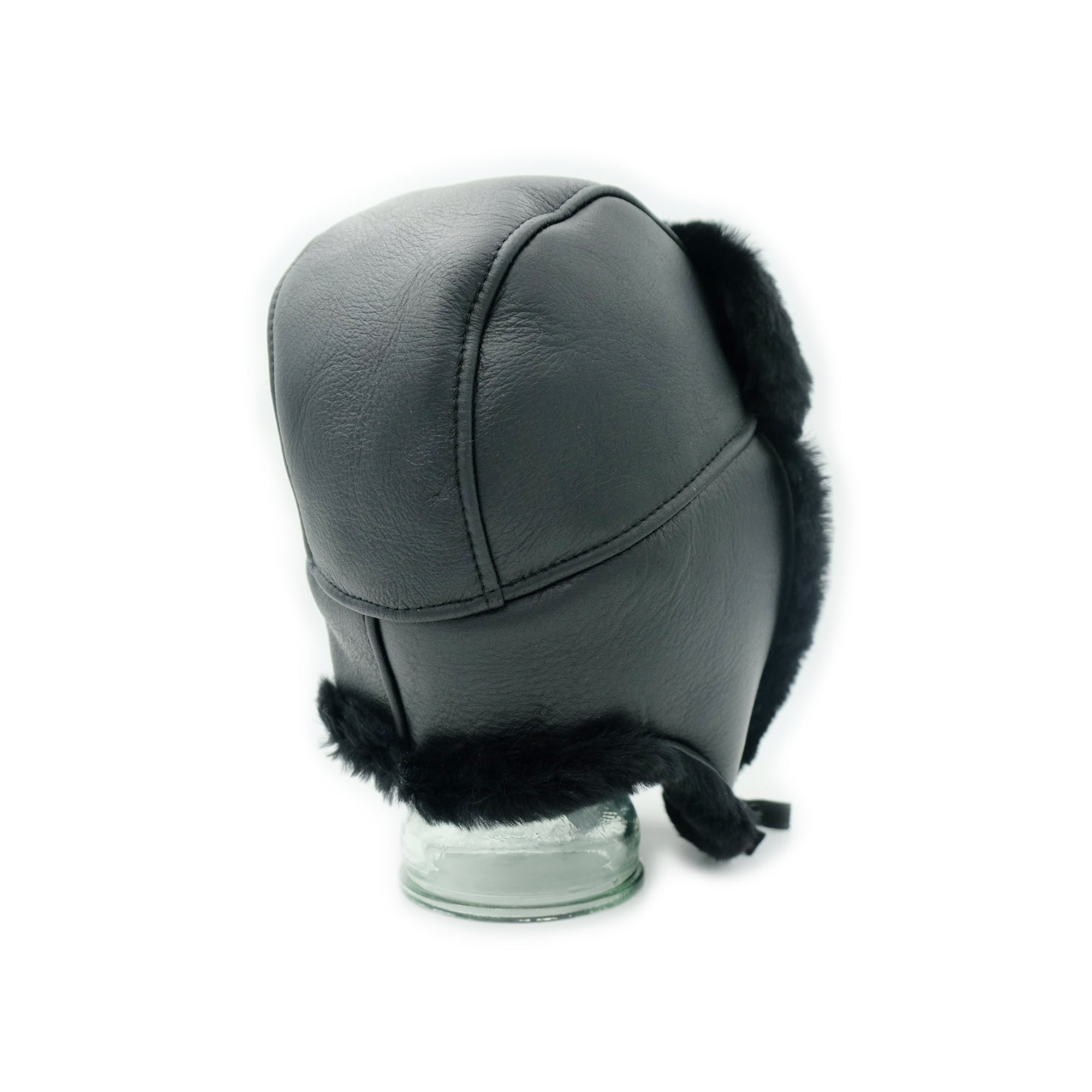 Grey leather and black sheepskin trapper hat displayed on stand, side view. - Yellow Earth Australia