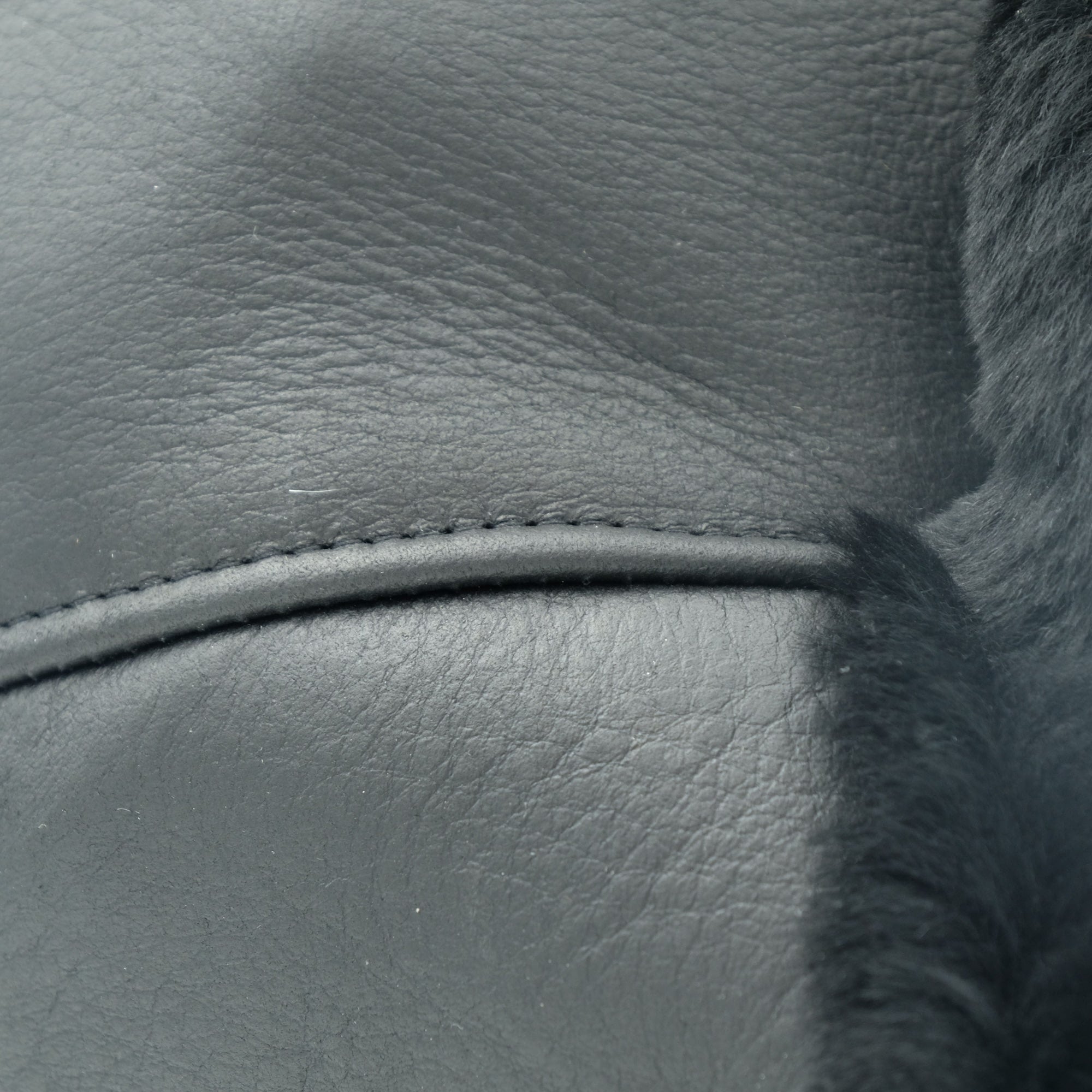 Grey sheepskin cushion cover featuring soft wool texture and piping detail, close-up view. - Yellow Earth Australia