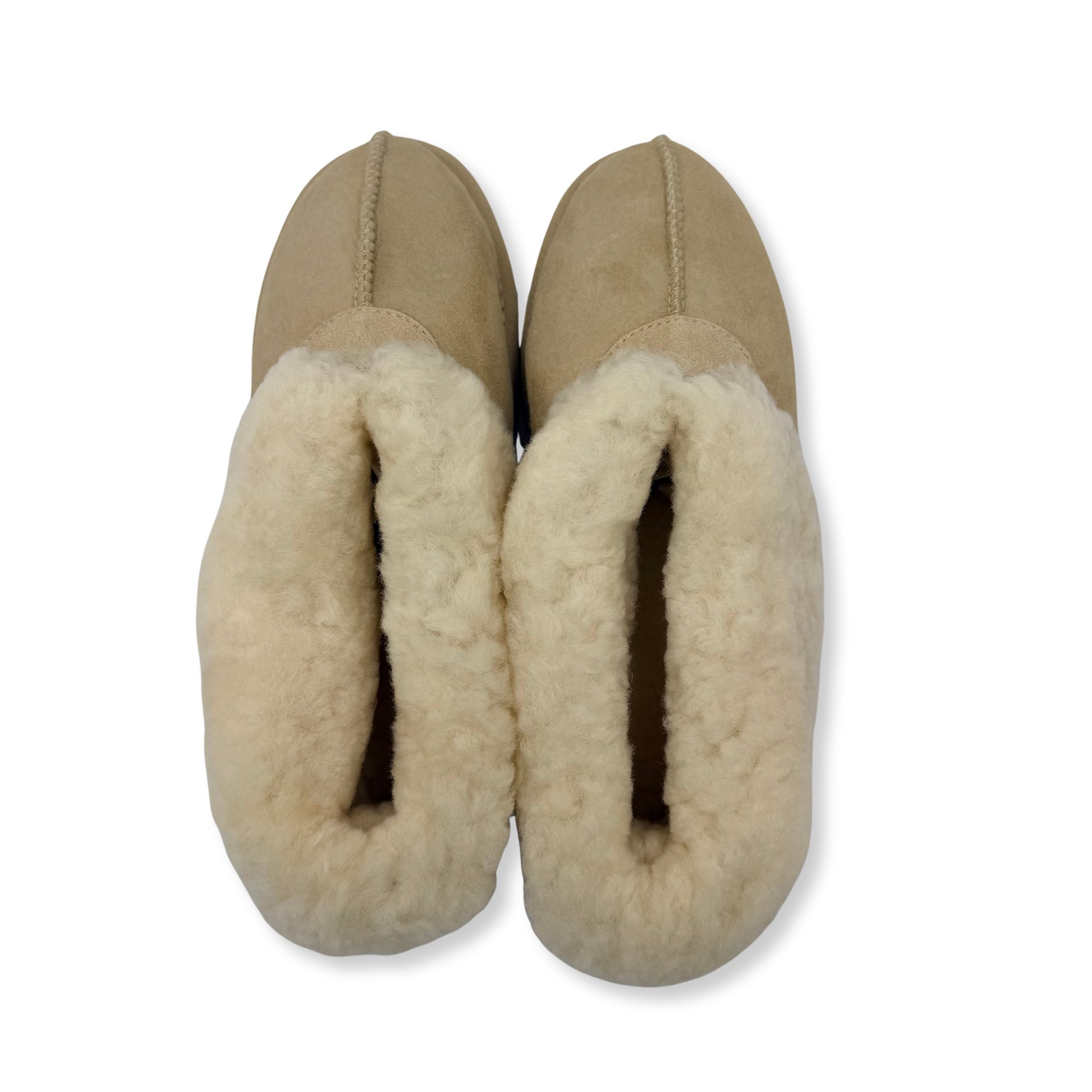 Pair of beige sheepskin boots with fluffy wool lining, top-down view. - Yellow Earth Australia