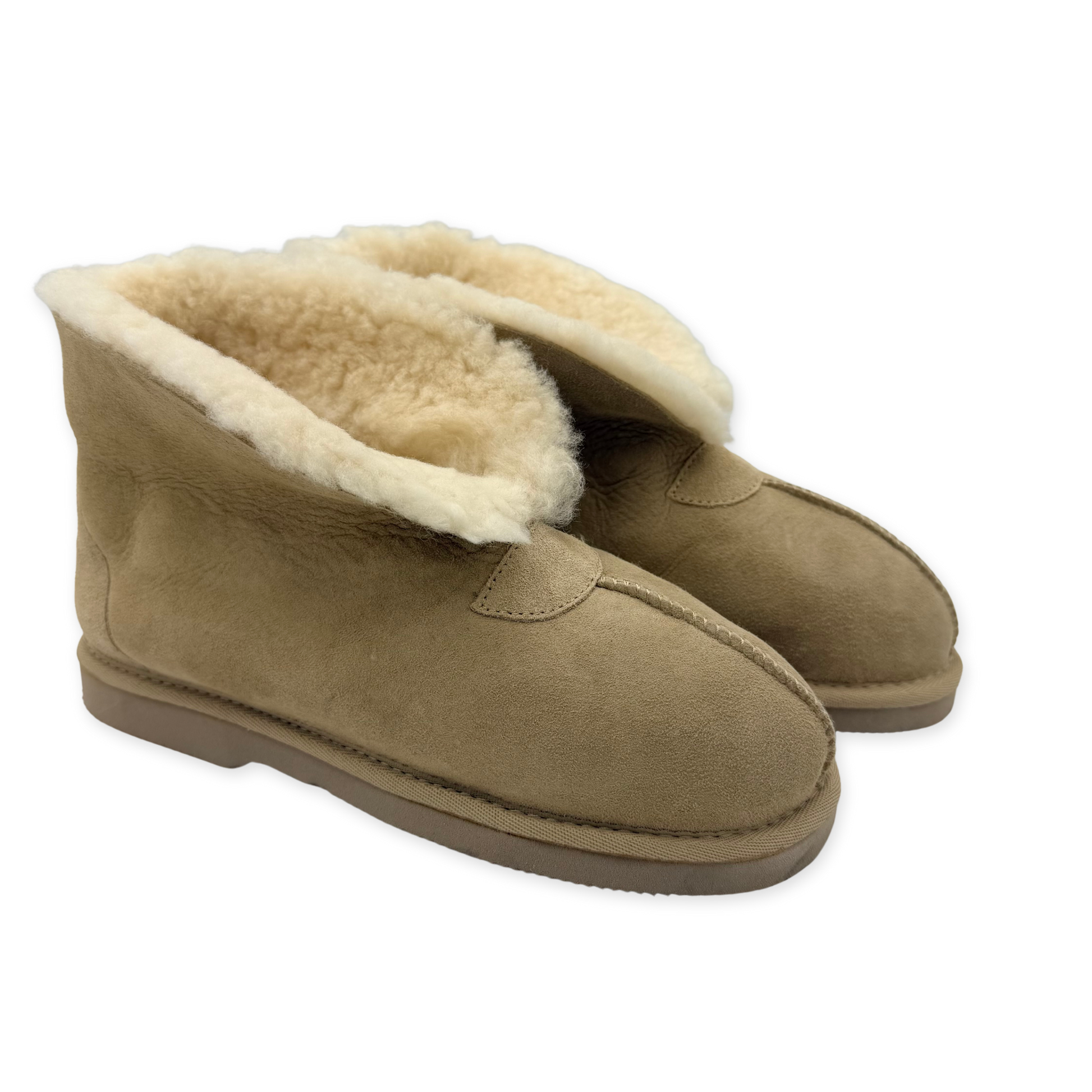 Pair of beige sheepskin boots with wool lining and suede exterior, shown from three-quarter view. - Yellow Earth Australia